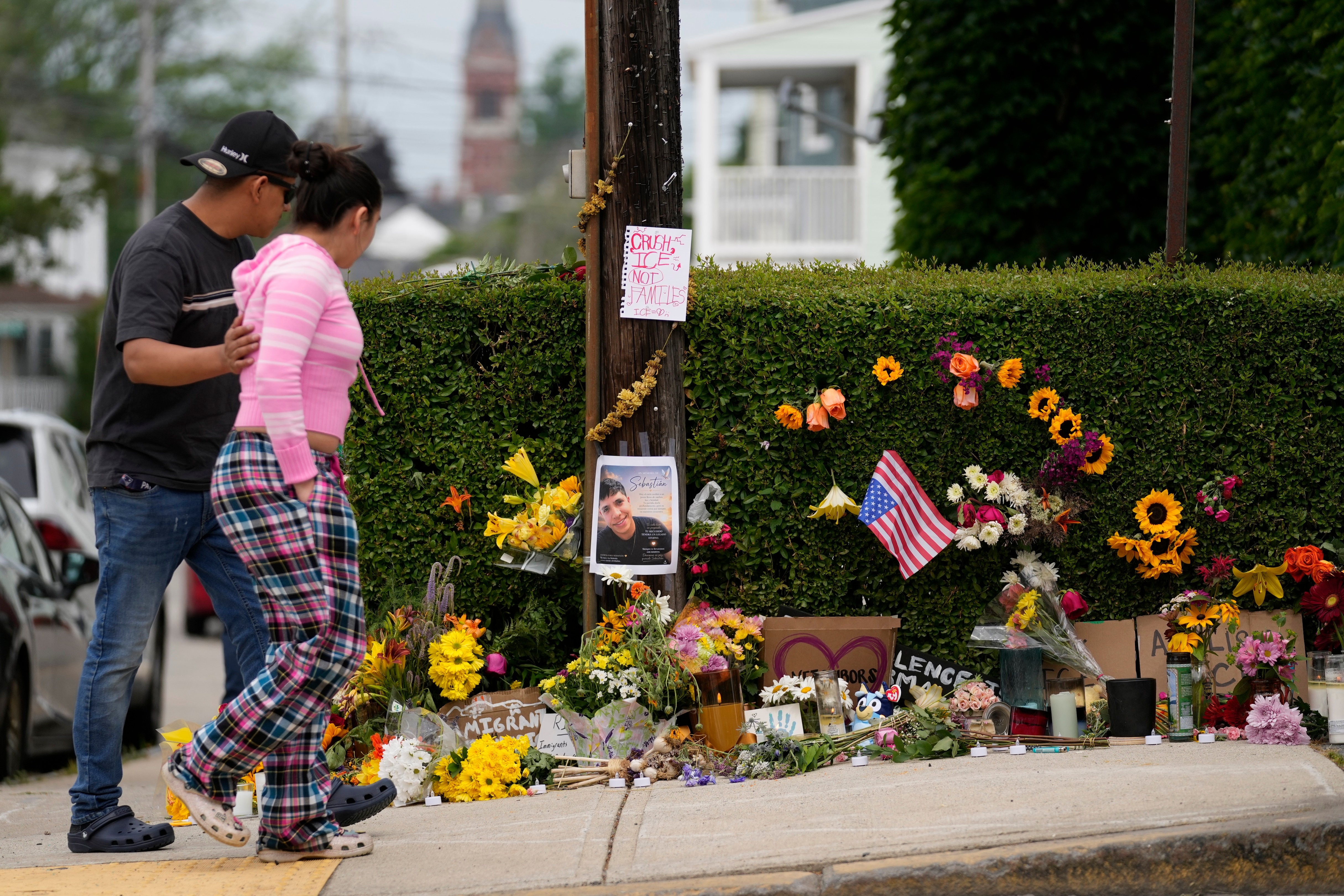 Local residents walk by a makeshift memorial to the victim of a shooting involving U.S. Immigration and Customs Enforcement in Biddeford, Maine.