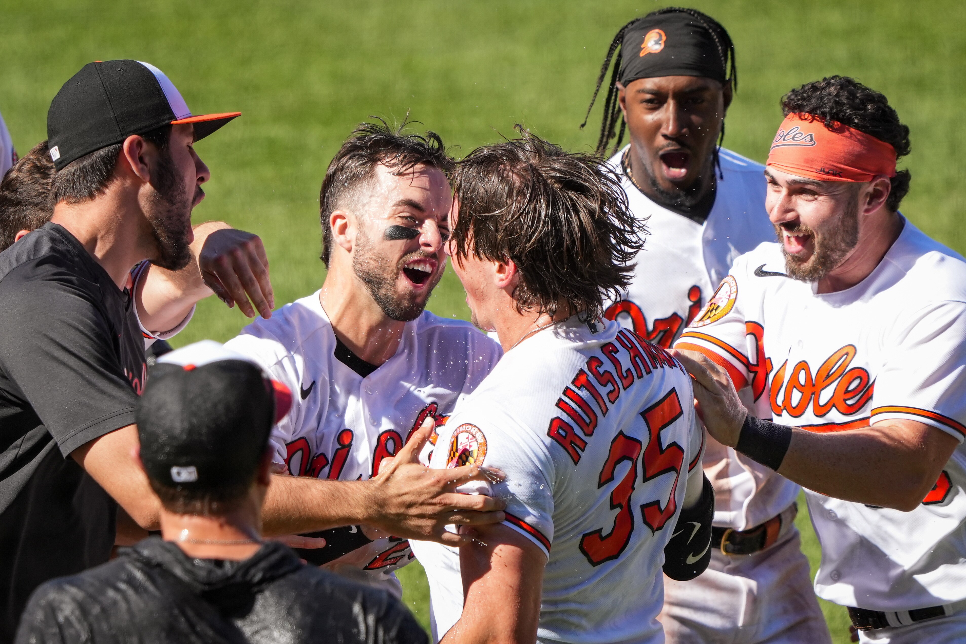 Teammates surround Orioles catcher Adley Rutschman after his first walk-off home run beat the Athletics on April 13.