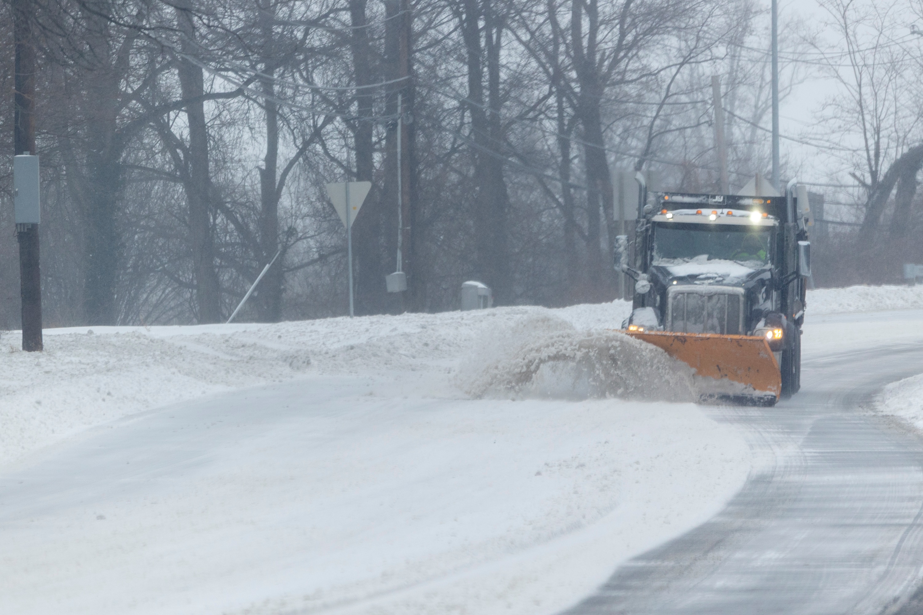 A snowplow travels south on Colesville Road on Sunday, Jan. 25, 2026, during a snowstorm in Silver Spring, Md.