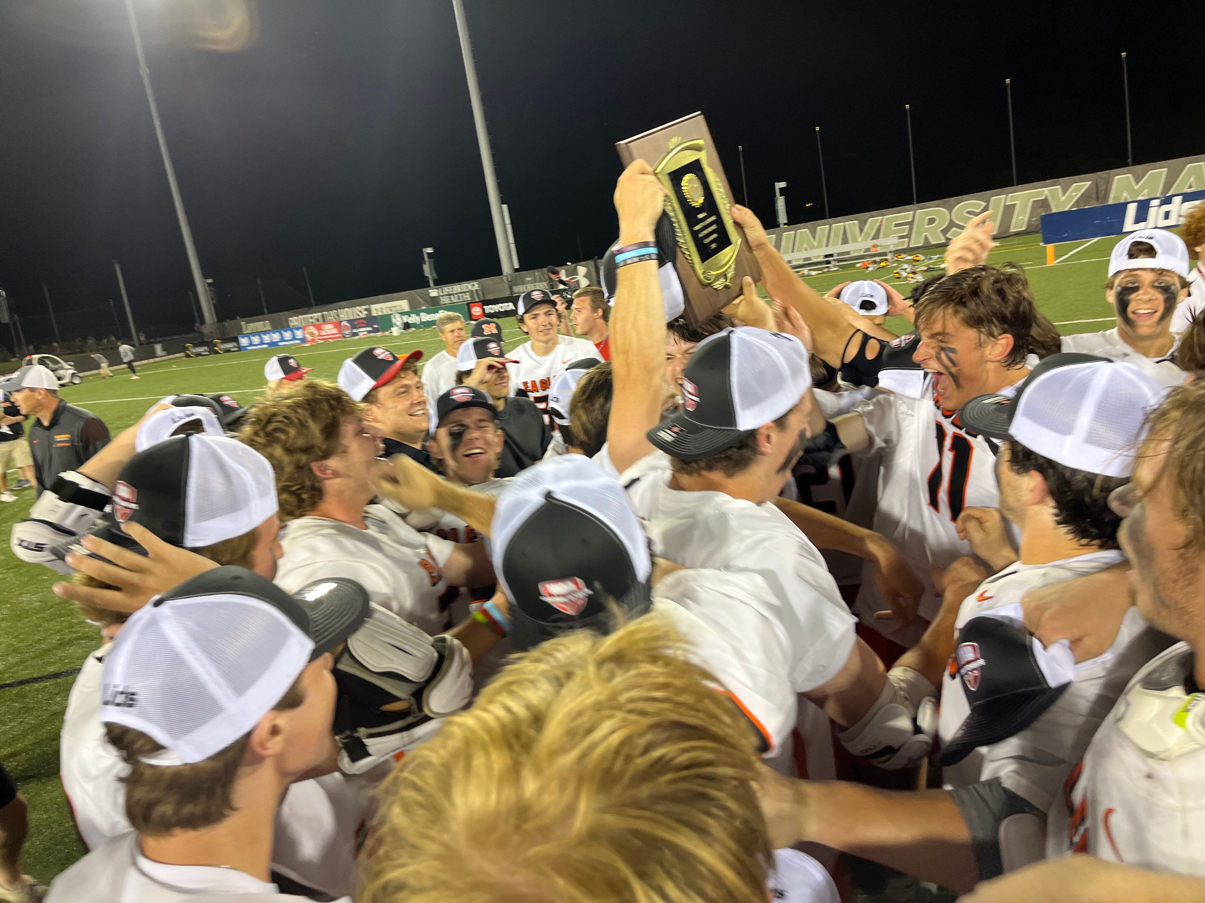 McDonogh lacrosse team holds up the MIAA A Conference championship plaque Friday evening. The No. 1 Eagles defeated second-ranked Calvert Hall for their second straight title and third since 2016.