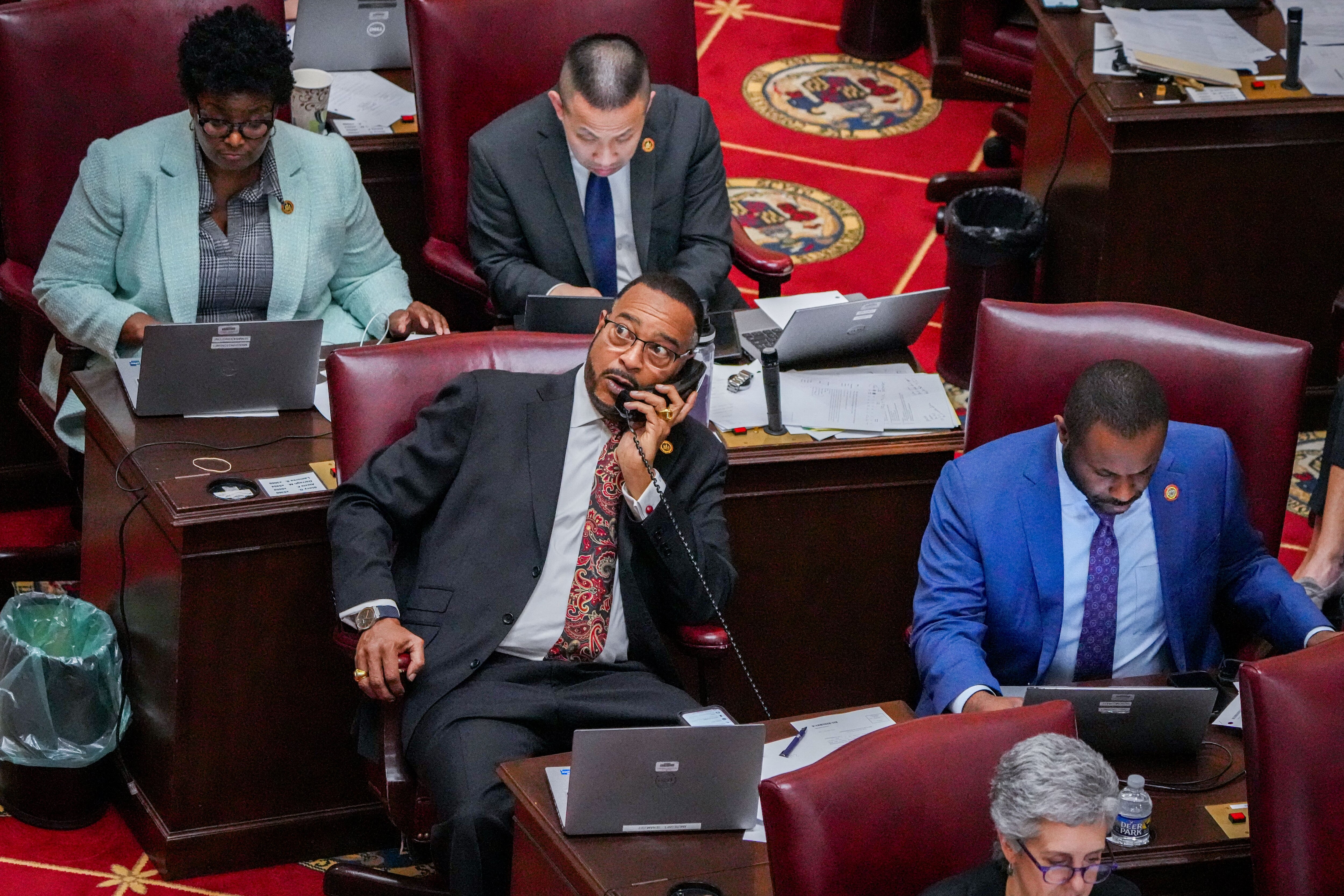 Sen. Anthony Muse (front left) takes a call in the Maryland State House during sine die, the final day of the 2024 General Assembly Session in Annapolis, on April 8, 2024. Any bill that doesn’t get passed by midnight is defeated for the year.