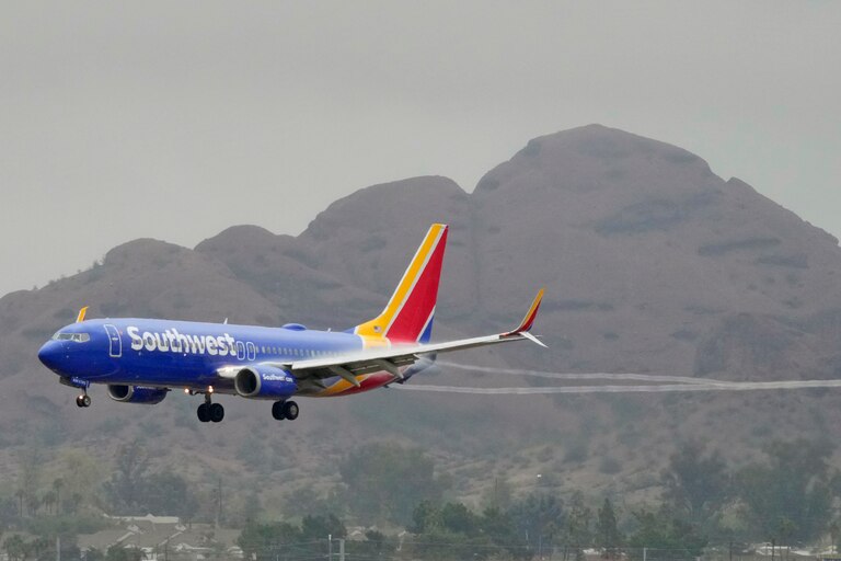 FILE - A Southwest Airlines jet arrives at Sky Harbor International Airport, Dec. 28, 2022, in Phoenix. With its flights now running on a roughly normal schedule, Southwest Airlines is turning its attention to luring back customers and repairing damage to a reputation for service after canceling 15,000 flights around Christmas. The disruptions started with a winter storm and snowballed when Southwest's ancient crew-scheduling technology failed.
