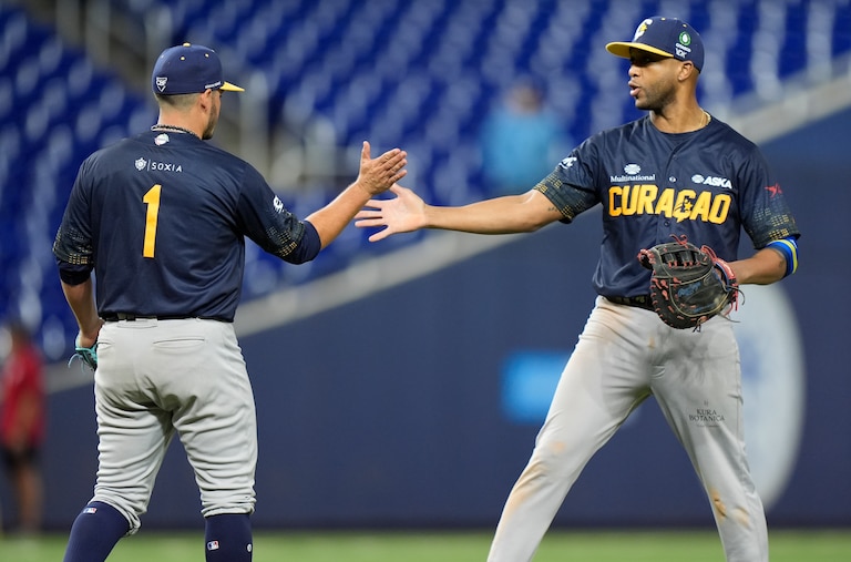 Curacao relief pitcher Anthony Herrera (1) and infielder Sharlon Schoop celebrate after Curacao beat Mexico, 6-5, during a Caribbean Series game in 2024.