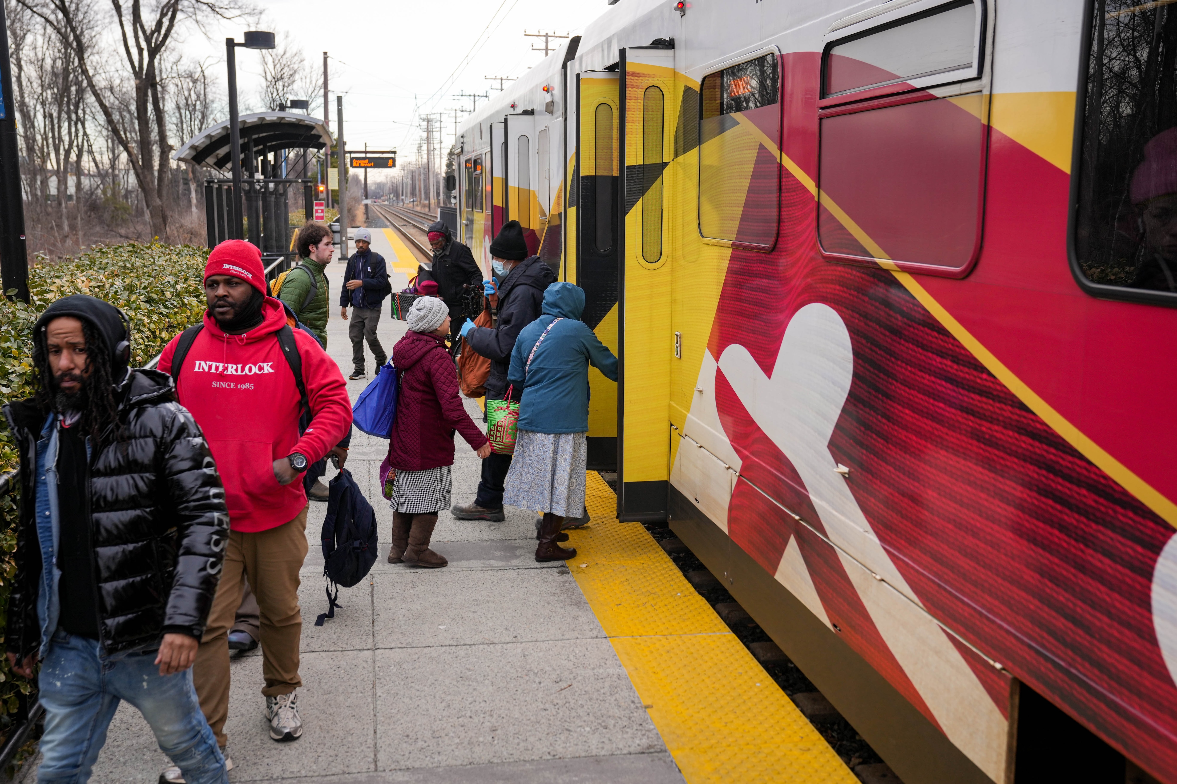 Passengers enter and exit the southbound light rail car as it arrives at the Lutherville Light Rail station in Lutherville, Md. on Monday, February 3, 2025.