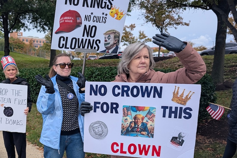 Melissa Mullins, right, and Amy Thompson have been to nine No Kings rallies, with signs that focus on the words crowns and clowns. About 600 people walked along Generals Highway and Bestgate Road on Oct. 17, 2026.