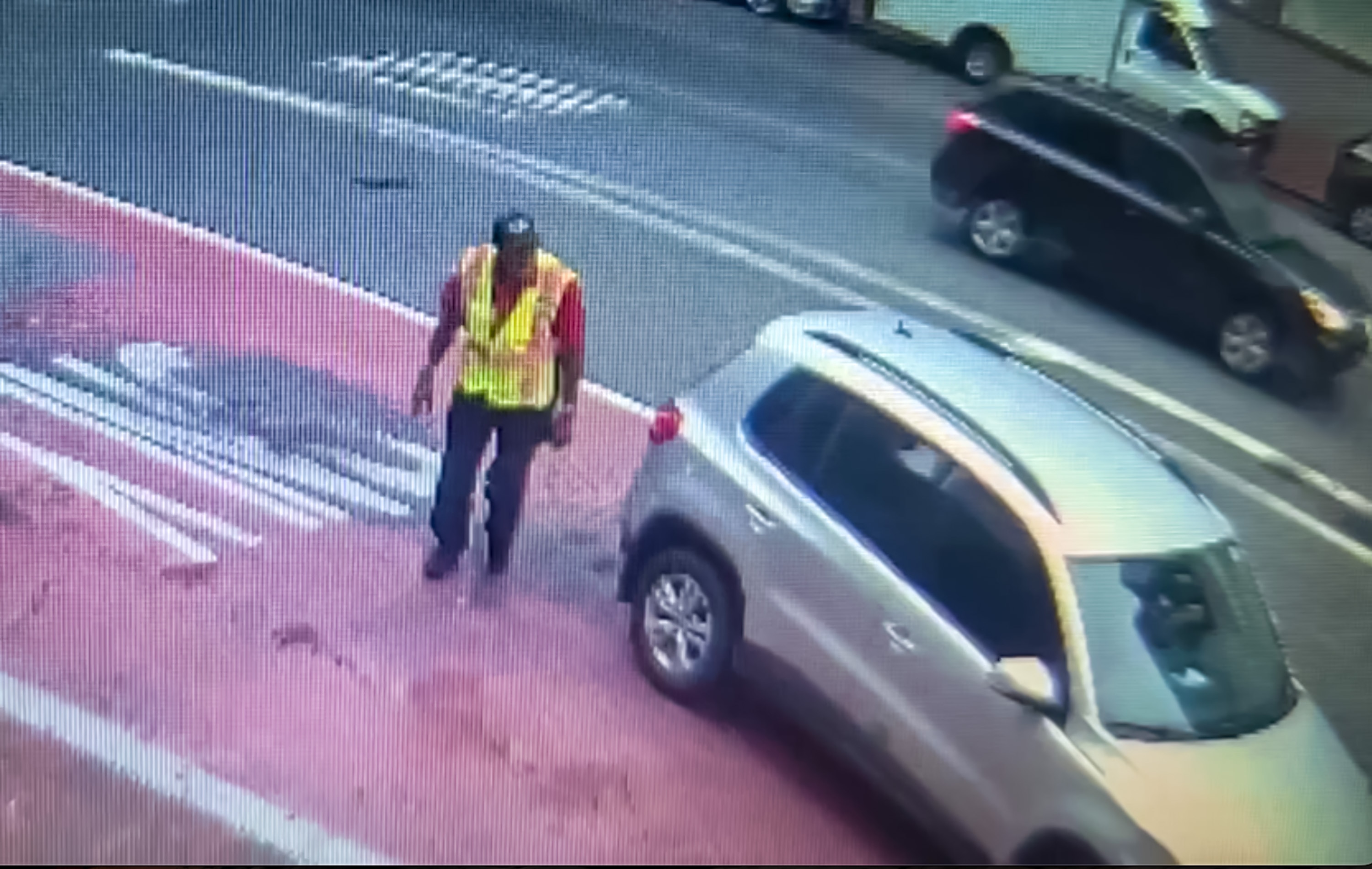 Screenshot from surveillance footage shows a driver getting out to check his vehicle for damage before driving away after striking a woman walking in downtown Baltimore on Sept. 3, 2026.