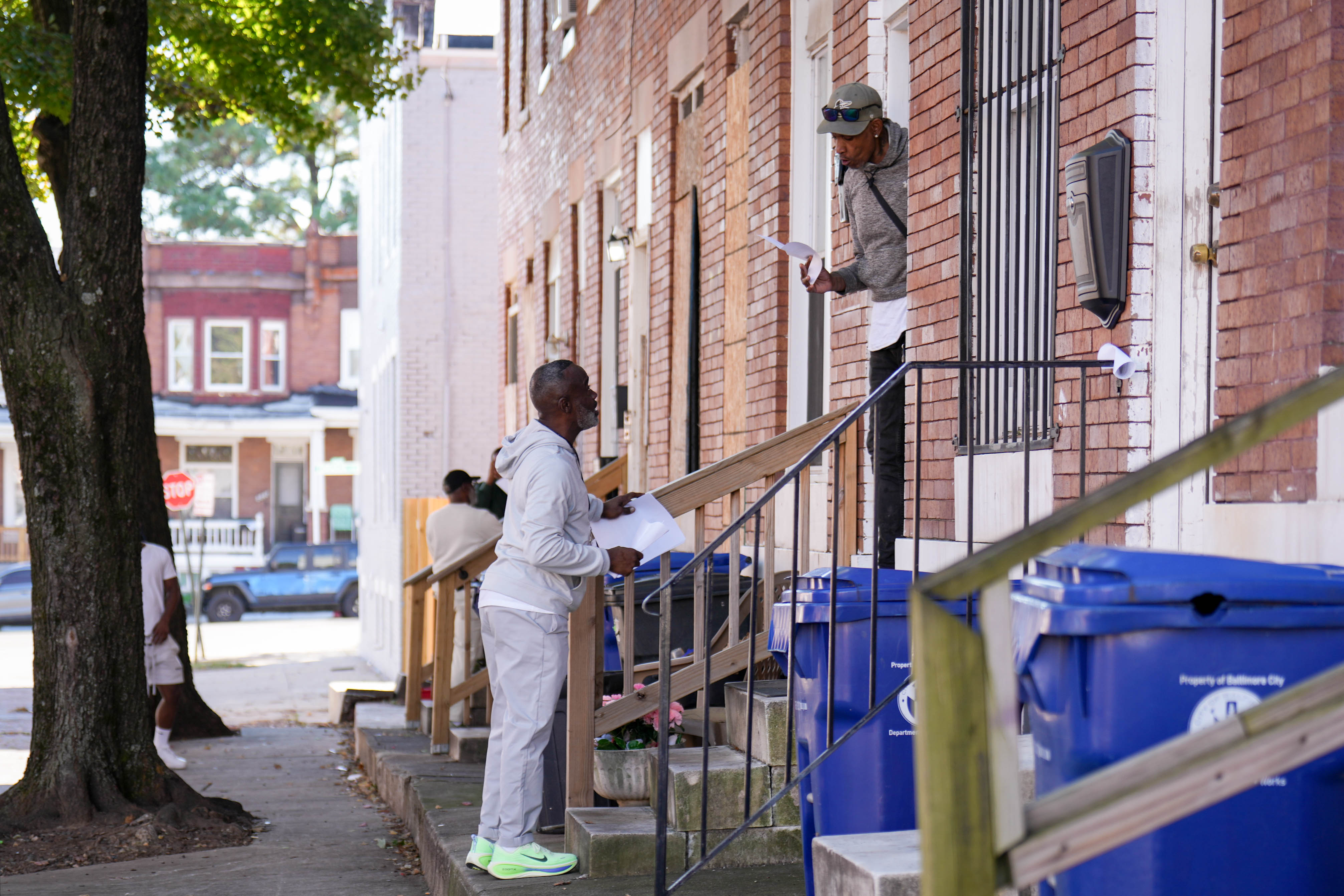 Mark McClelland, Community Stabilization Coordinator with MONSE, left, speaks with resident Don’nel Brooks in the Academy Heights neighborhood of Baltimore, Md. on Tuesday, October 20, 2026. McClelland and other members of his group canvassed the surrounding communities to assess the need for resources following a shooting in the area over the weekend.