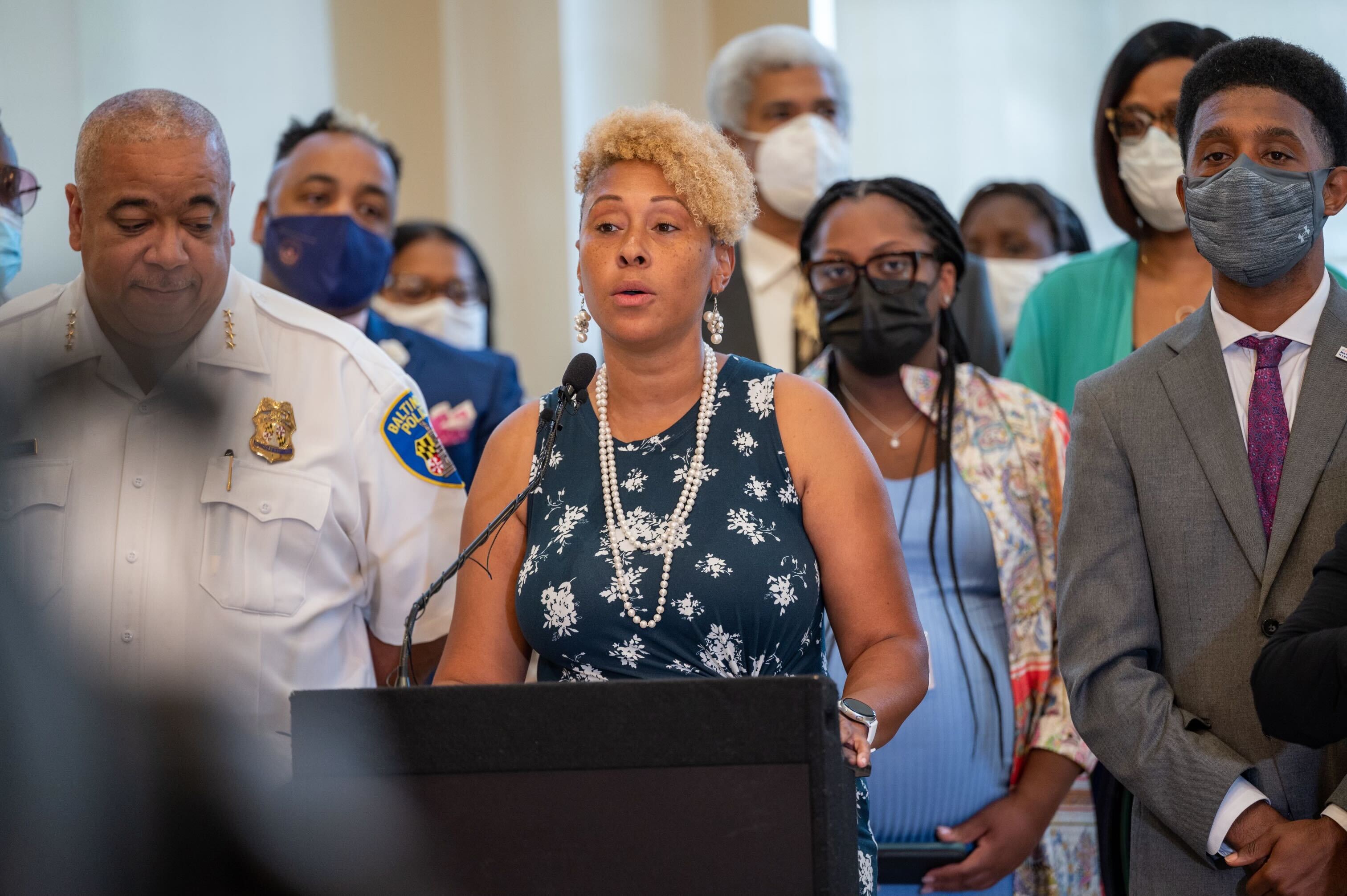 From left, Baltimore Police Commissioner Michael Harrison, Shantay Jackson, and Mayor Brandon Scott discuss a victim services report at Our Daily Bread.