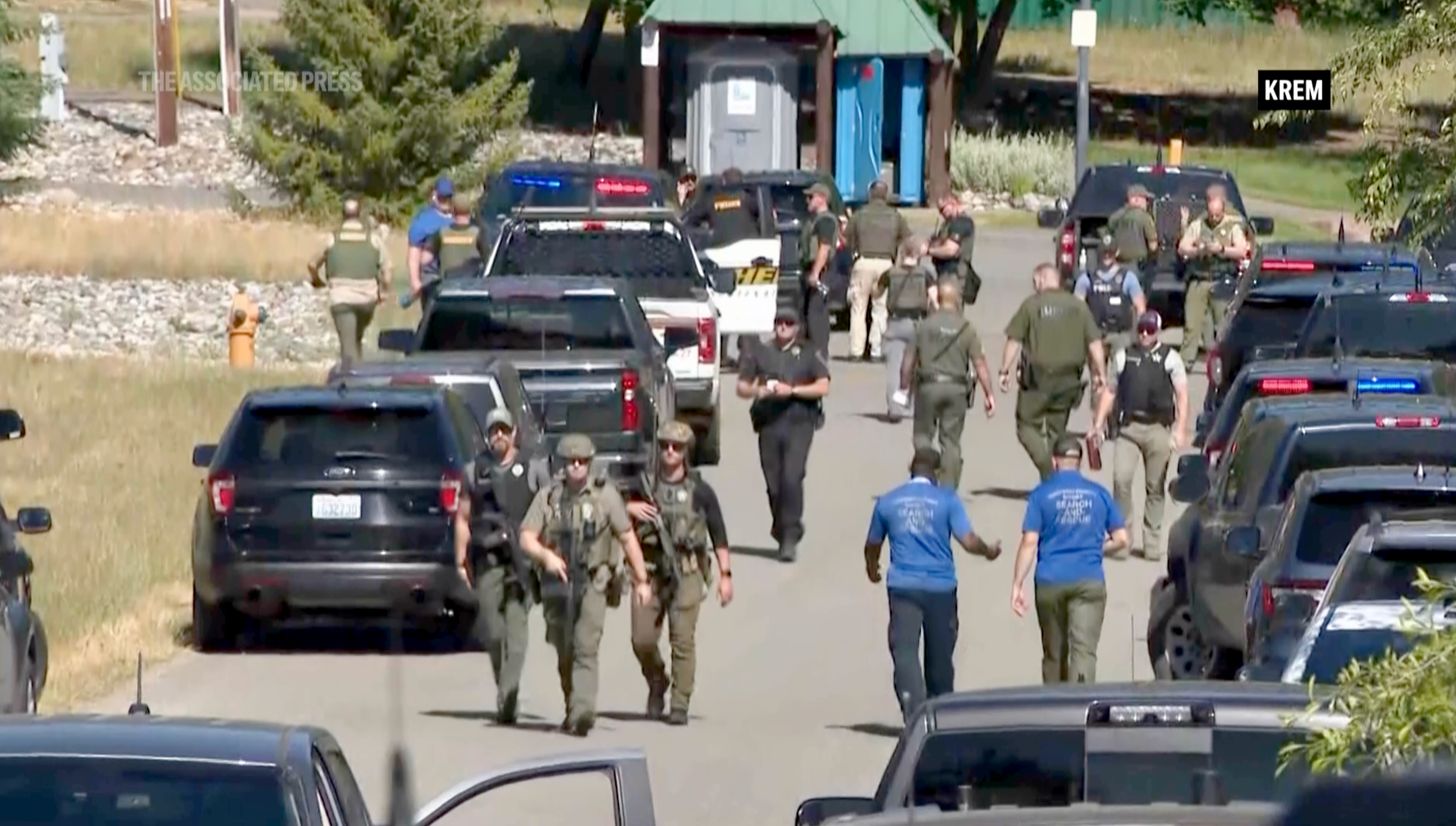 Law enforcement and first responders on the scene in Kootenai County, Idaho, after two firefighters were killed Sunday and another wounded when they were ambushed by sniper fire while responding to a blaze in a northern Idaho mountain community.