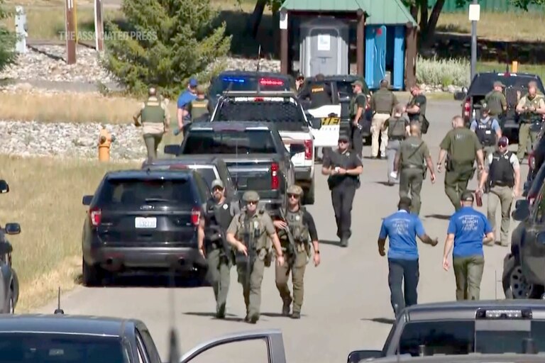 Law enforcement and first responders on the scene in Kootenai County, Idaho, after two firefighters were killed Sunday and another wounded when they were ambushed by sniper fire while responding to a blaze in a northern Idaho mountain community.