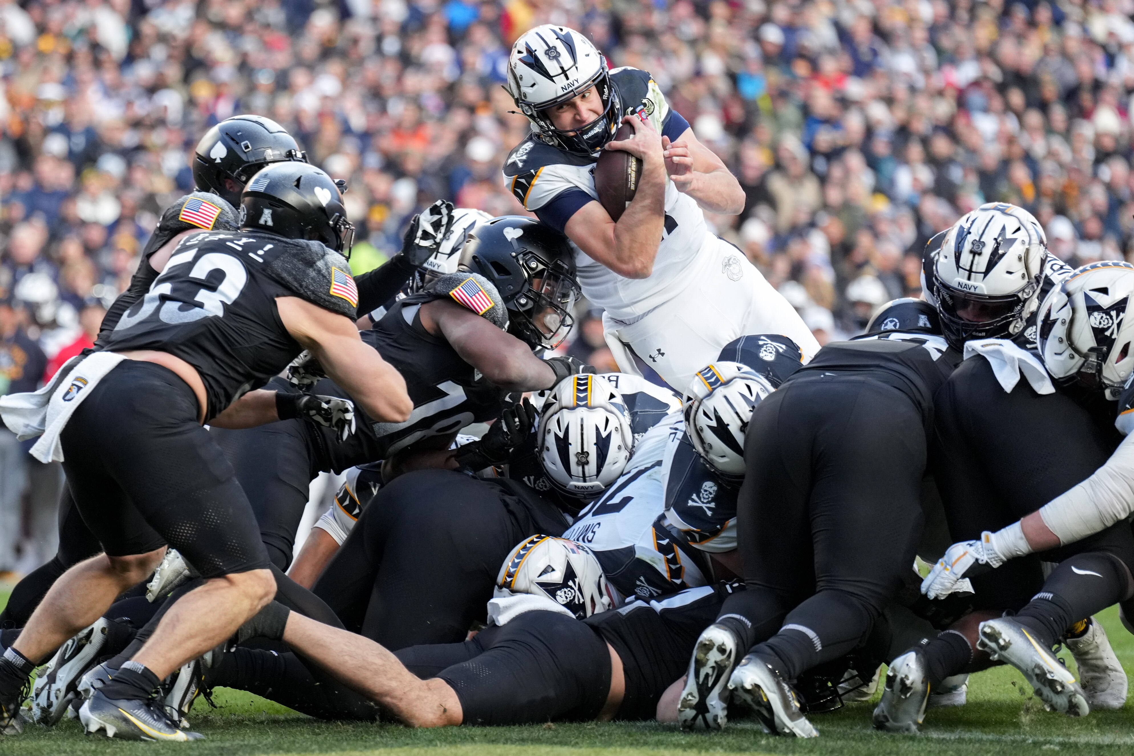 Navy quarterback Blake Horvath (11) leaps over the pile to score a touchdown in the first quarter of the 125th Annual Army-Navy Game held at Northwest Stadium in Landover, Md. on Saturday, December 14, 2024.