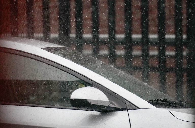 Rains splashes a car as a thunderstorm hits during a jiu jitsu lesson at Guardian Baltimore, a non-profit martial arts studio, in Baltimore, Md. on Thursday, July 31, 2025.