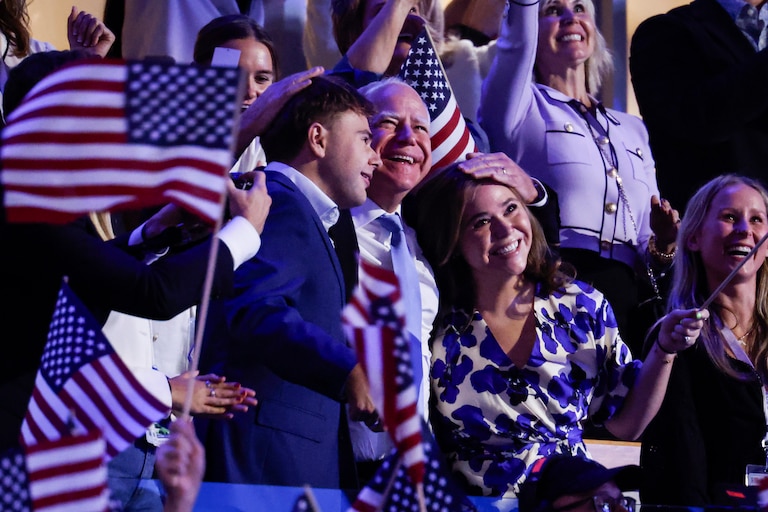 Minnesota Gov. Tim Walz, center, hugs his children during the final day of the 2024 Democratic National Convention in Chicago, Ill.