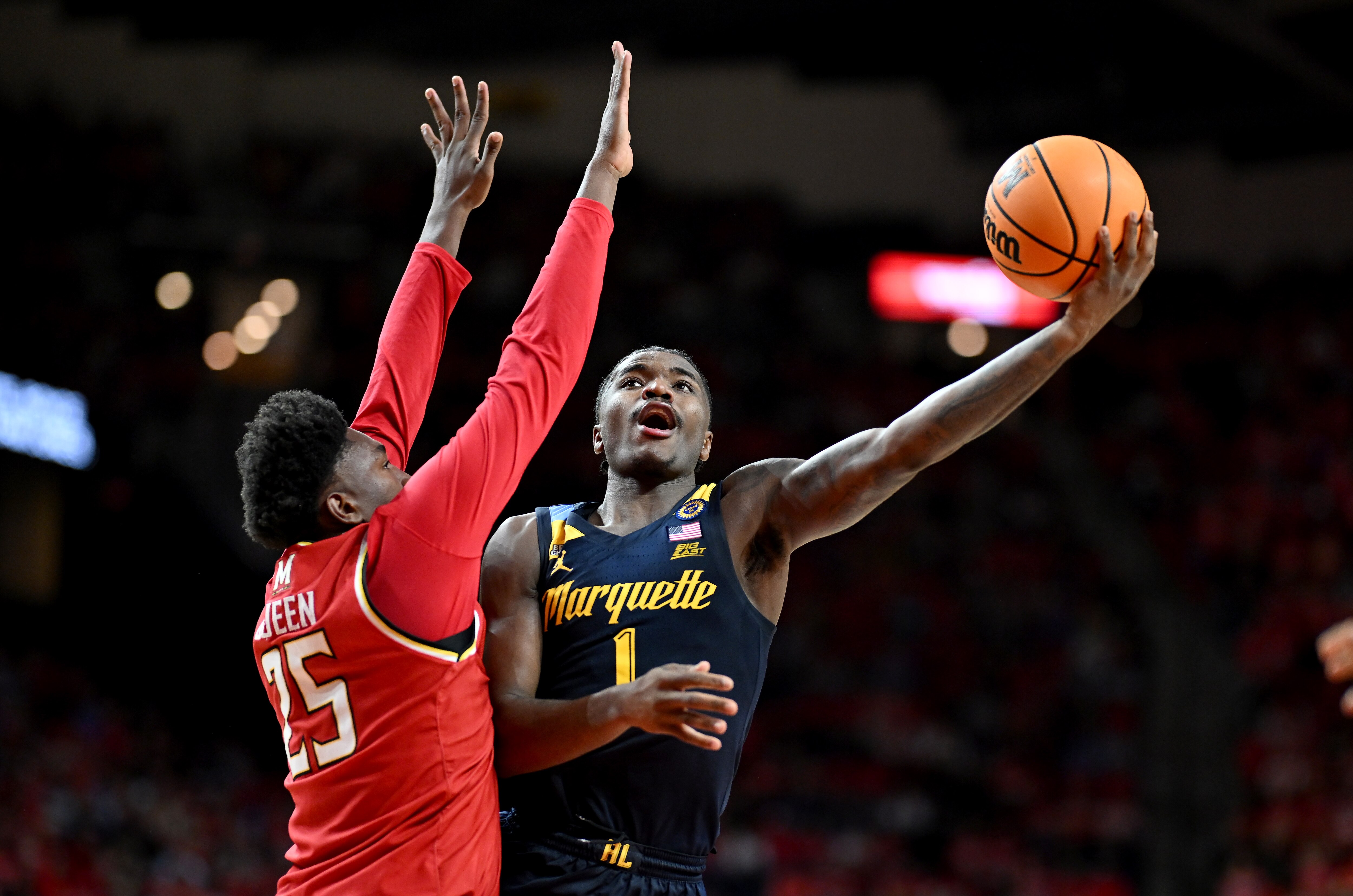 Kam Jones of Marquette takes a shot against Maryland defender Derik Queen on Friday night in College Park.