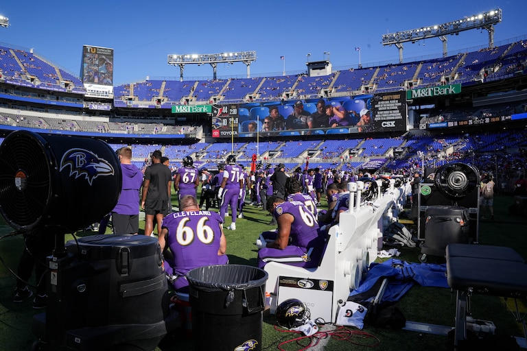 Baltimore Ravens players sit on the bench, while many fans have already left early in the fourth quarter of a game against the Houston Texans at M&T Bank Stadium in Baltimore, Md., on Sunday, Oct. 5, 2025.