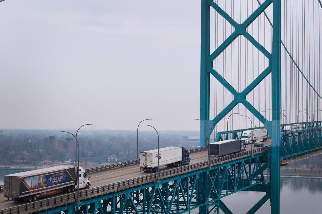 In this aerial view, trucks cross the Ambassador Bridge as they carry cargo between Canada and the United States.