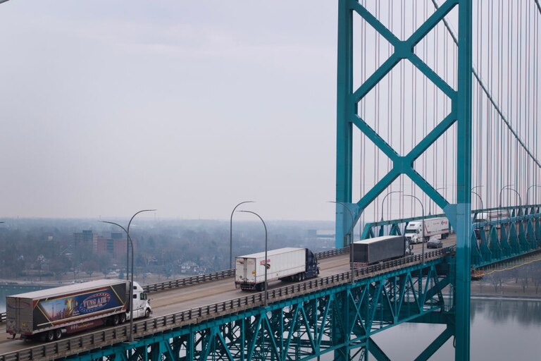 In this aerial view, trucks cross the Ambassador Bridge as they carry cargo between Canada and the United States.