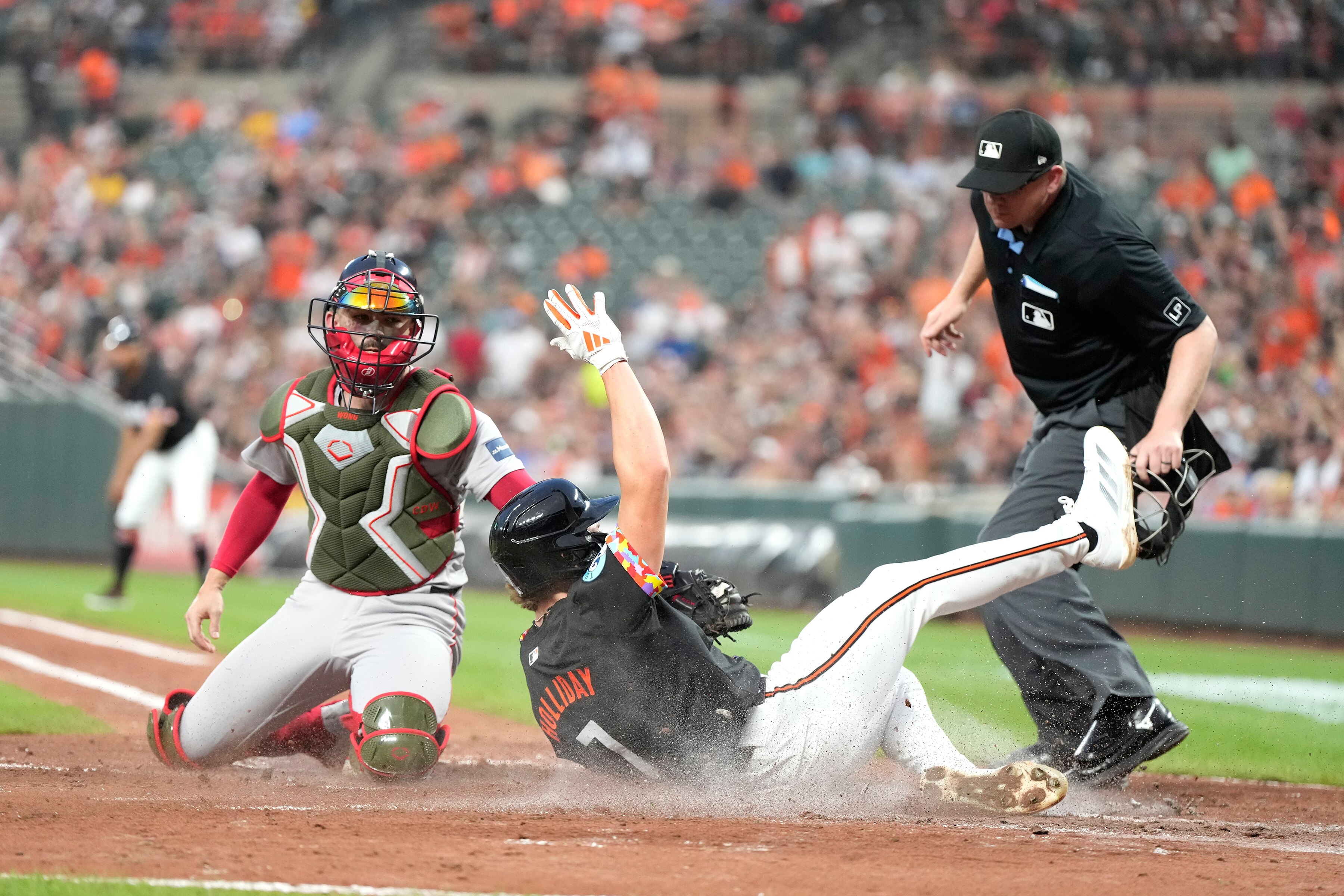 Jackson Holliday beats the tag by Connor Wong to score on a hit by Ramón Urías in the second inning.