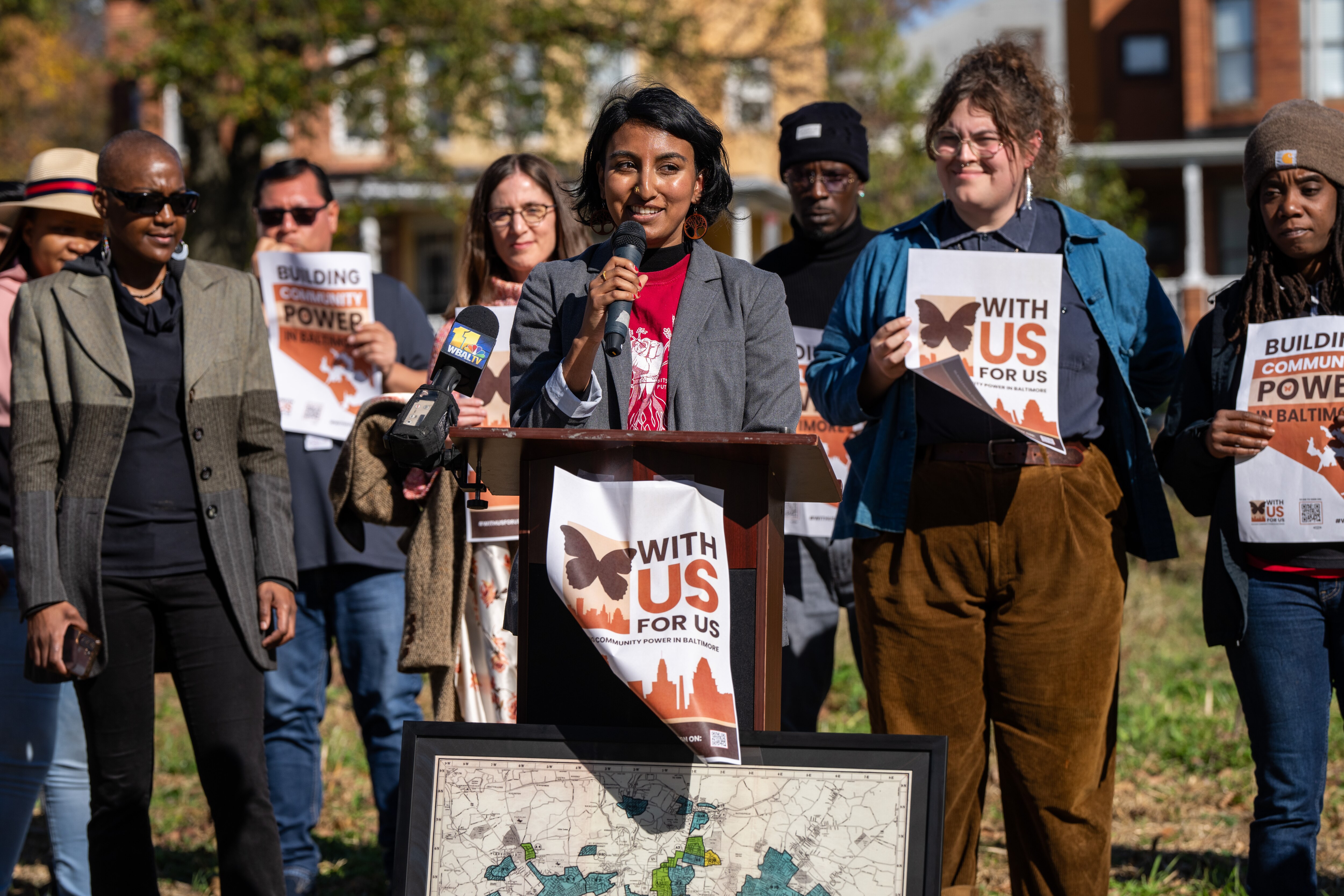 1199SEIU Senior Policy Analyst Loraine Arikat speaks during a 2023 kickoff event for With Us for Us, a coalition seeking to increase what nonprofits pay the city each year for services.