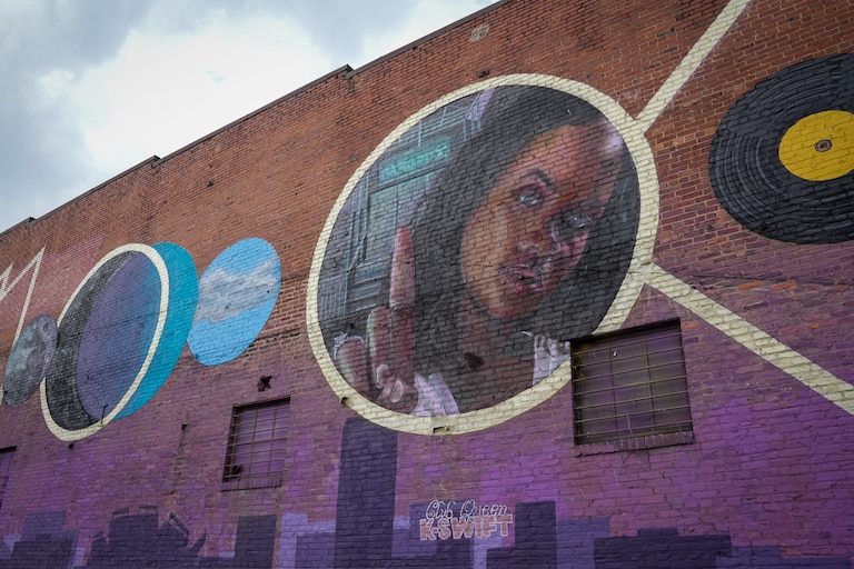 A mural of DJ K-Swift is painted on the wall of Hammerjacks in South Baltimore, painted by artist Nether410.