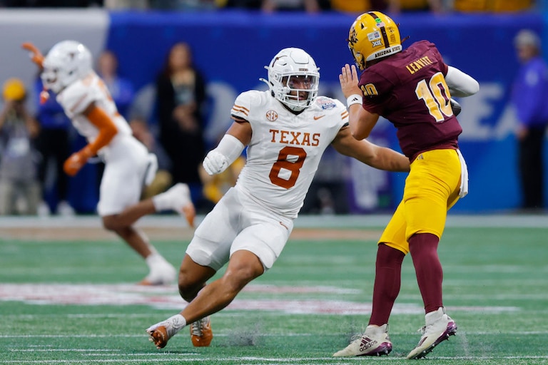 Texas linebacker Trey Moore sacks Arizona State quarterback Sam Leavitt during the second quarter of the Chick-fil-A Peach Bowl on Jan. 1, 2025.