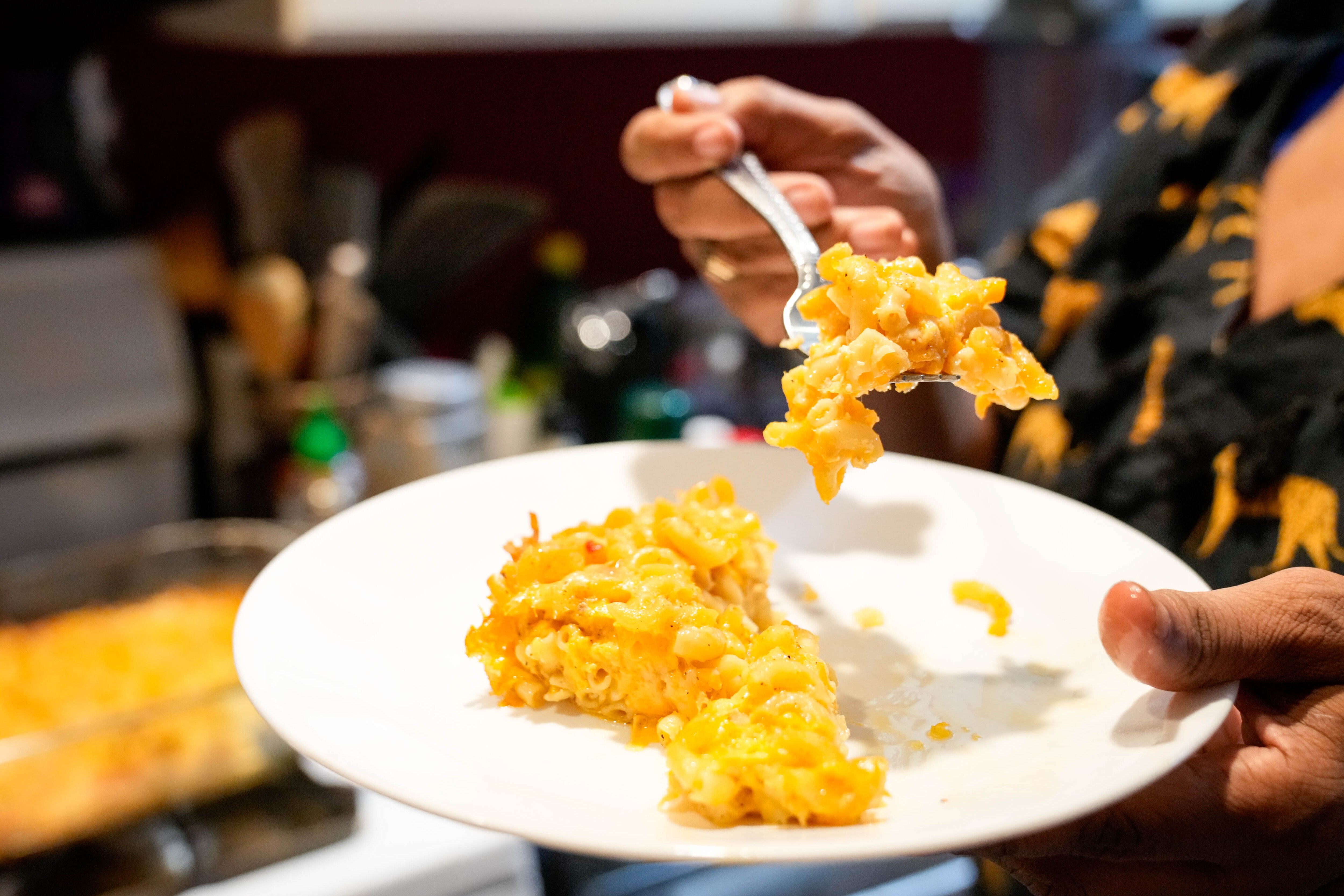 Leslie Gray Streeter forks a scoop of her freshly baked mac and cheese in Baltimore.