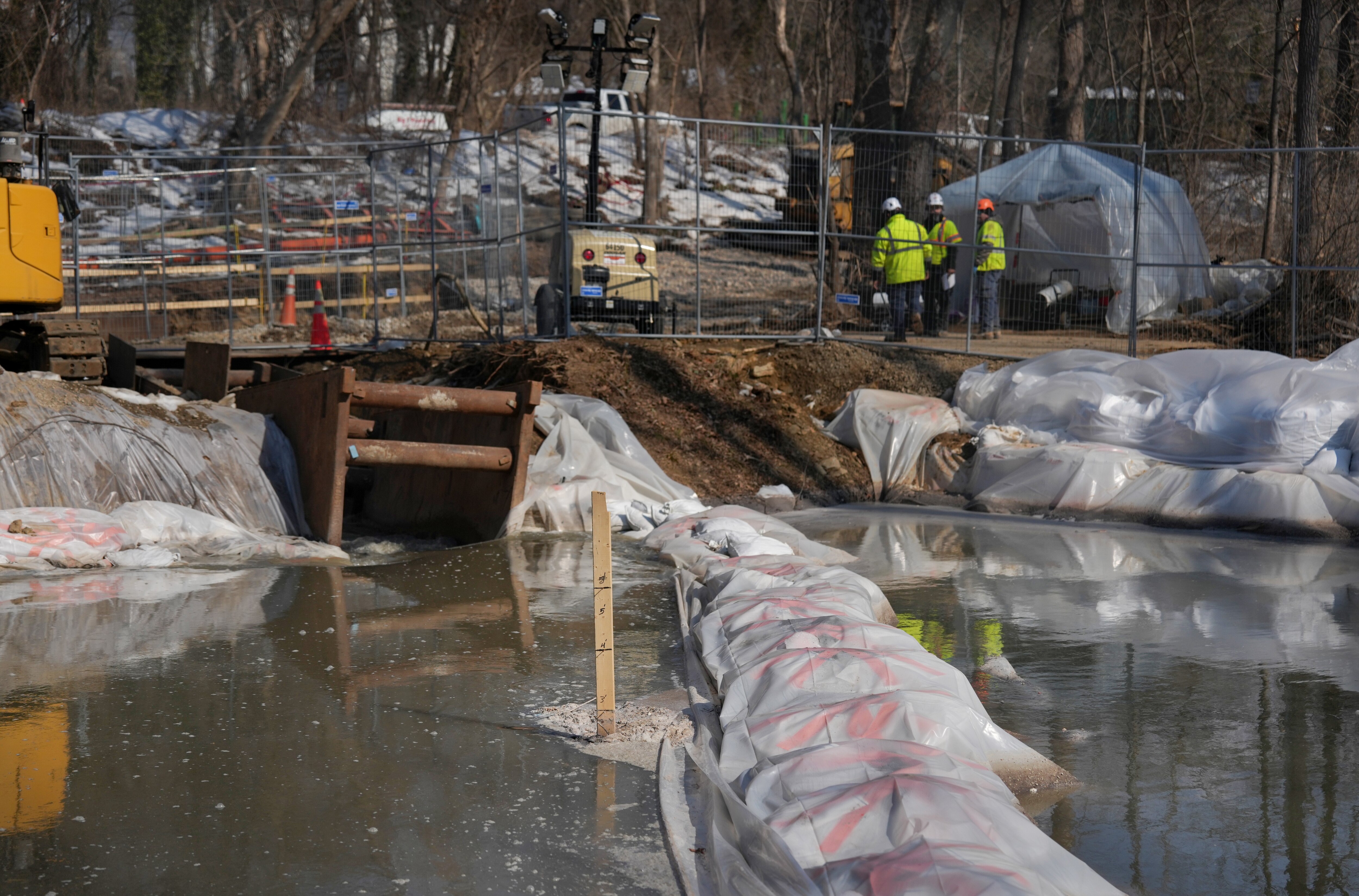 Contractors work on the collapsed Potomac Interceptor sewer line as the rerouted sewage flows down the C&O Canal next to the Clara Barton Parkway in Cabin John last month.