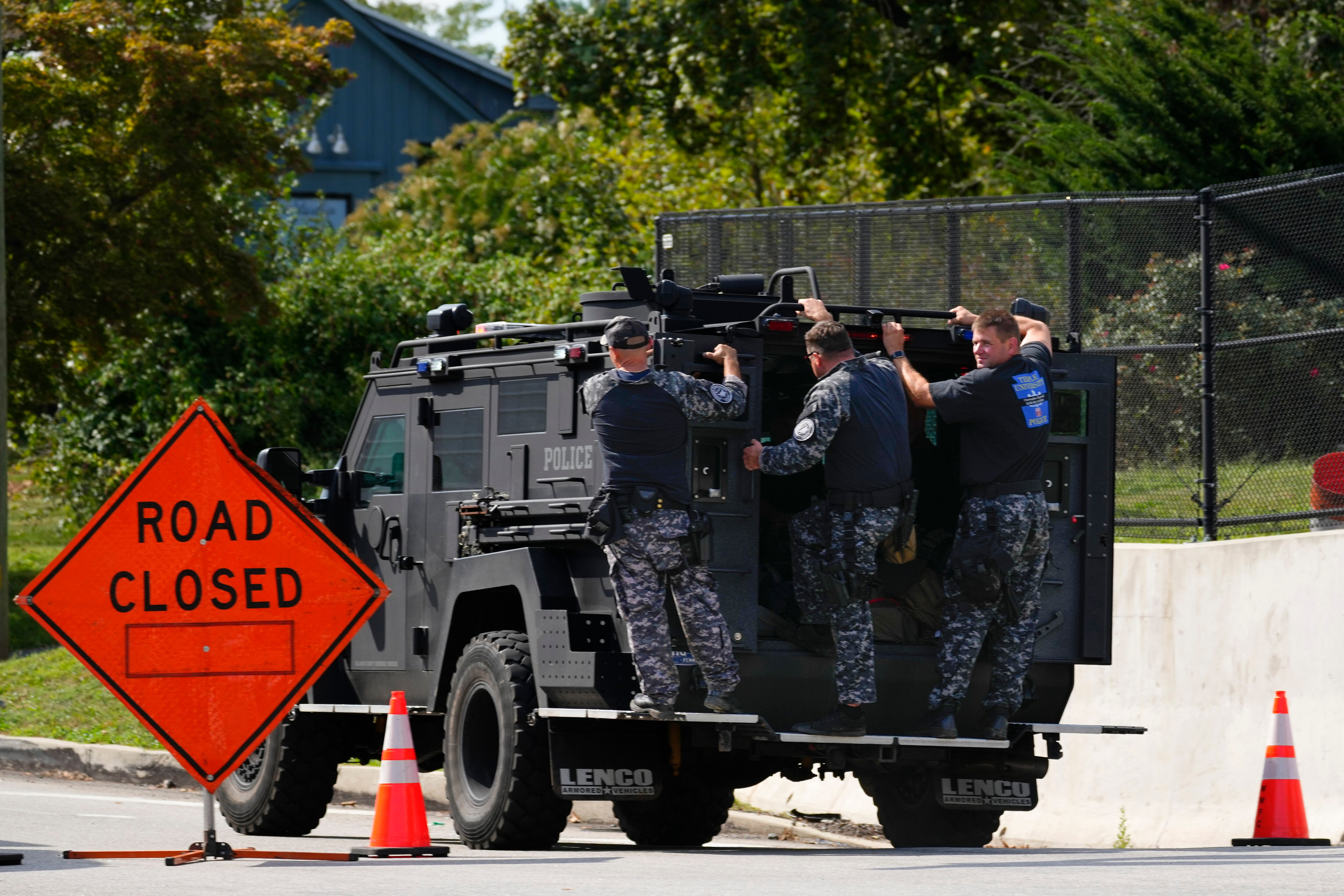 Law enforcement officers ride by a roadblock as the search for escaped convict Danelo Cavalcante continues in Pottstown, Pennsylvania, Tuesday, Sept. 12, 2023.