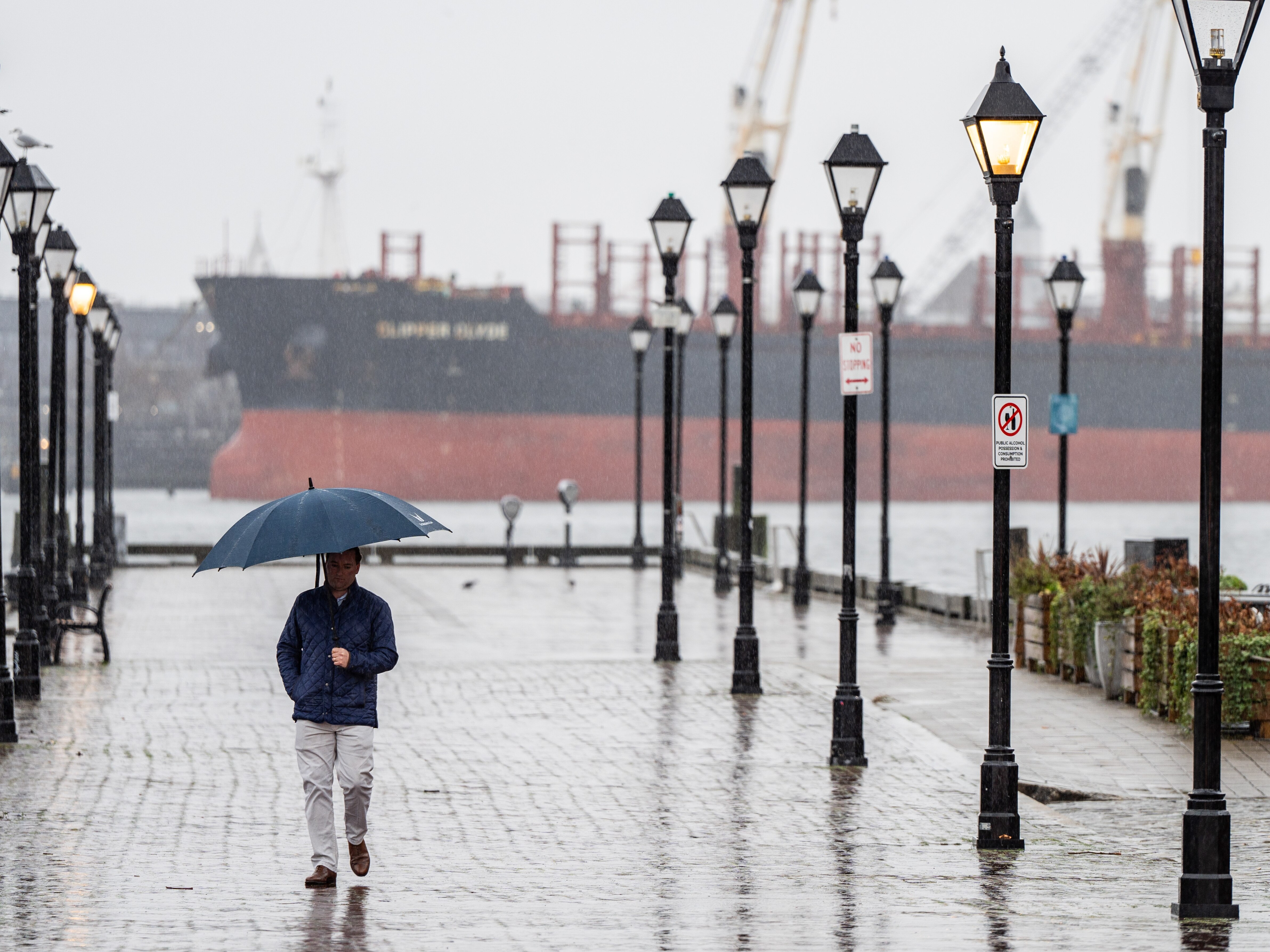 A person walks through Fells Point on a rainy Tuesday, Jan. 9, 2024.