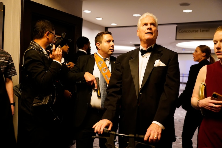 Agents escort people out of the Washington Hilton after an incident at the annual White House Correspondents Association Dinner April 25, 2026 in Washington, DC. The president is making his first appearance at the event which he has shunned from in the past.