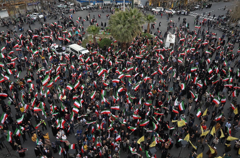 A group of demonstrators wave Iranian flags in support of the government and against U.S. and Israeli strikes in Tehran, Iran, Saturday, Feb. 28, 2026. (AP Photo/Vahid Salemi)