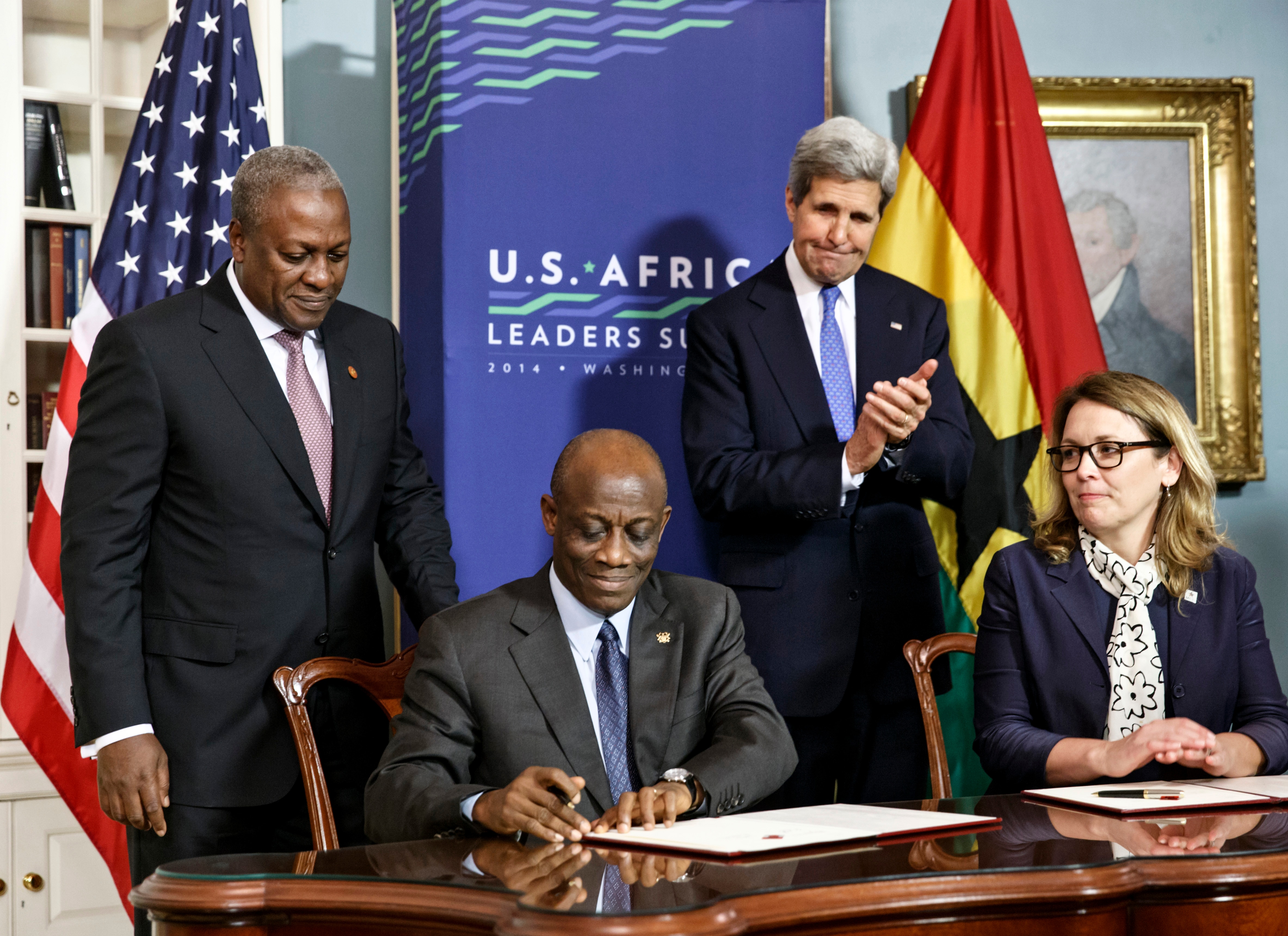 FILE - From left, Ghana's President John Dramani Mahama, Ghana's Finance Minister Seth Terkper, Secretary of State John Kerry, and CEO of the Millennium Challenge Corporation Dana Hyde, participate in the Ghana Compact signing ceremony during the US Africa Leaders Summit at the State Department in Washington on Aug. 5, 2014. A business jet may have experienced problems with its stability before encountering turbulence or some other roughness that caused the death of Hyde, who served in prominent posts in two presidential administrations, officials said Monday, March 6, 2023.