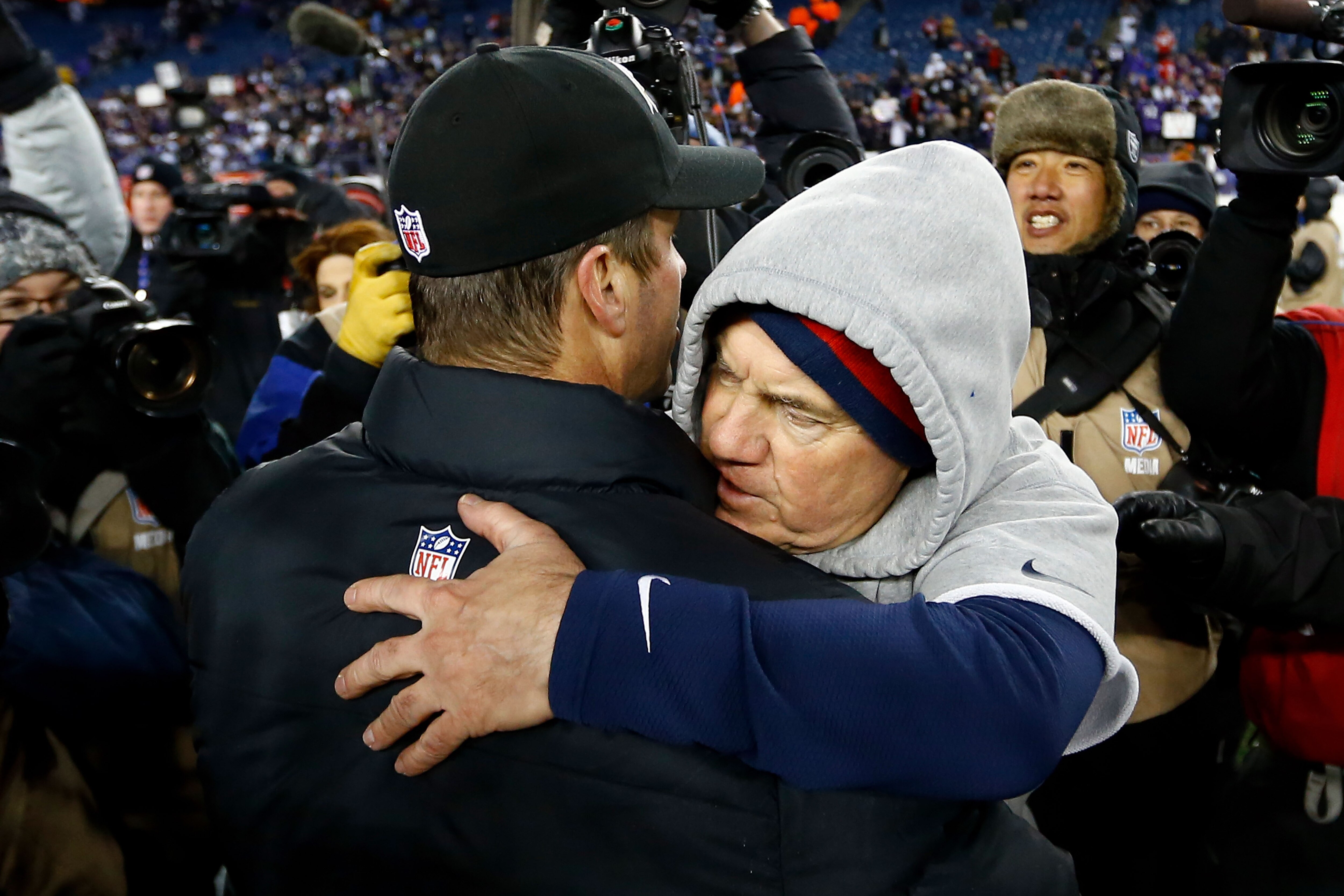 Ravens coach John Harbaugh, shown here hugging Bill Belichick after Baltimore beat New England in the AFC championship game in 2013, believes his former rival will thrive in his new job.
