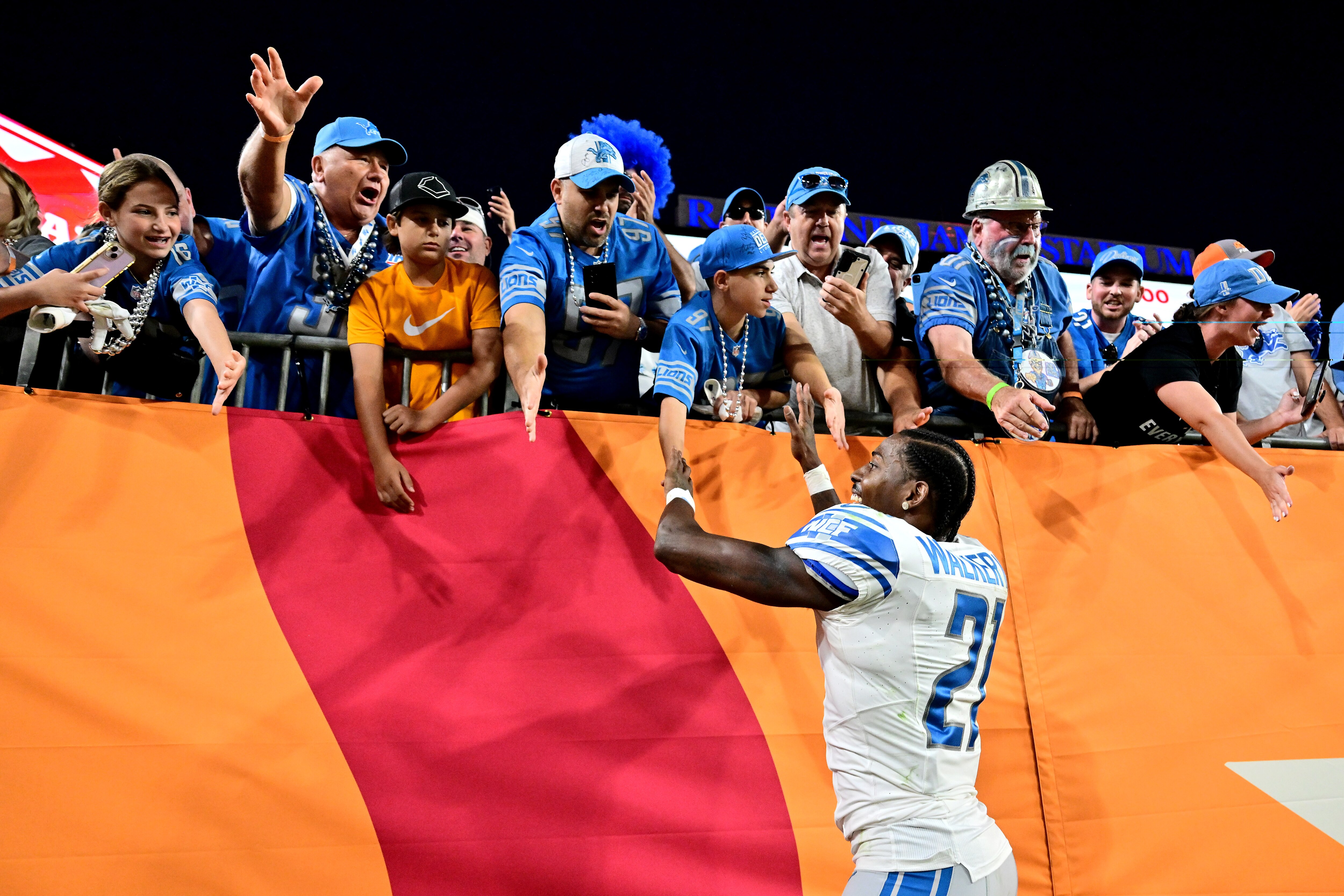 Tracy Walker III of the Lions high-fives fans after Detroit's 20-6 win against at Tampa Bay on Sunday.