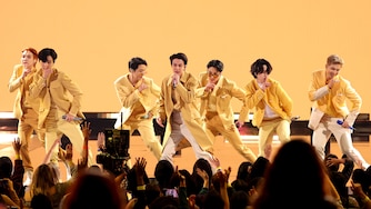 LOS ANGELES, CALIFORNIA - NOVEMBER 21: (L-R) Suga, V, J-Hope, Jin, Jungkook, Jimin, and RM of BTS perform onstage during the 2021 American Music Awards at Microsoft Theater on November 21, 2021 in Los Angeles, California.