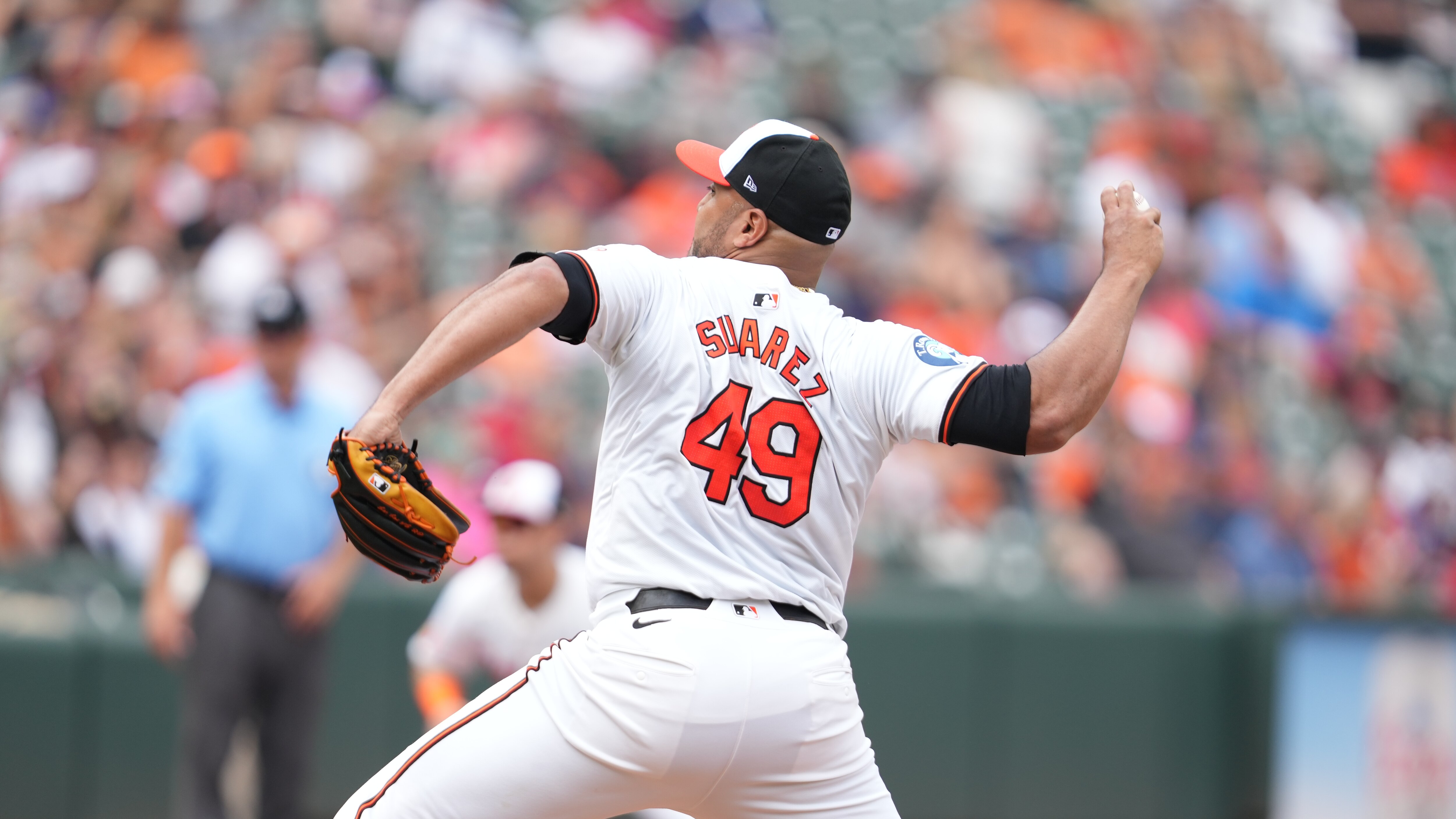 BALTIMORE, MD - AUGUST 18:  Albert Suárez #49 of the Baltimore Orioles pitches in the first inning during a baseball game against the Boston Red Sox at Oriole Park at Camden Yards on August 18, 2024 in Baltimore, Maryland.  (Photo by Mitchell Layton/Getty Images)