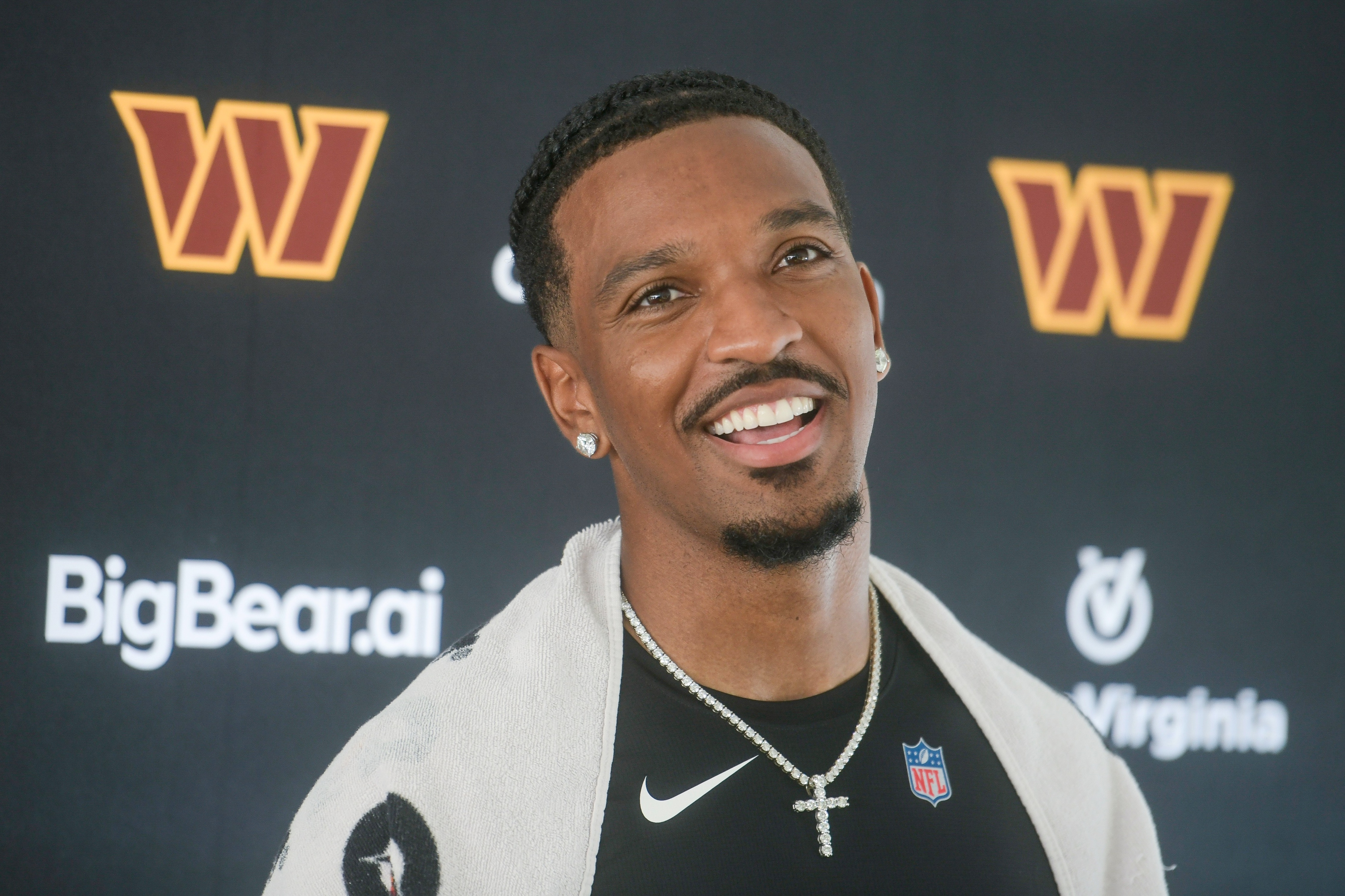 Washington Commanders quarterback Jayden Daniels talks to reporters following training camp practice on July 29.