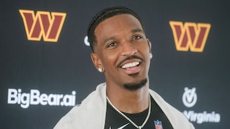 Washington Commanders quarterback Jayden Daniels talks to reporters following training camp practice on July 29.