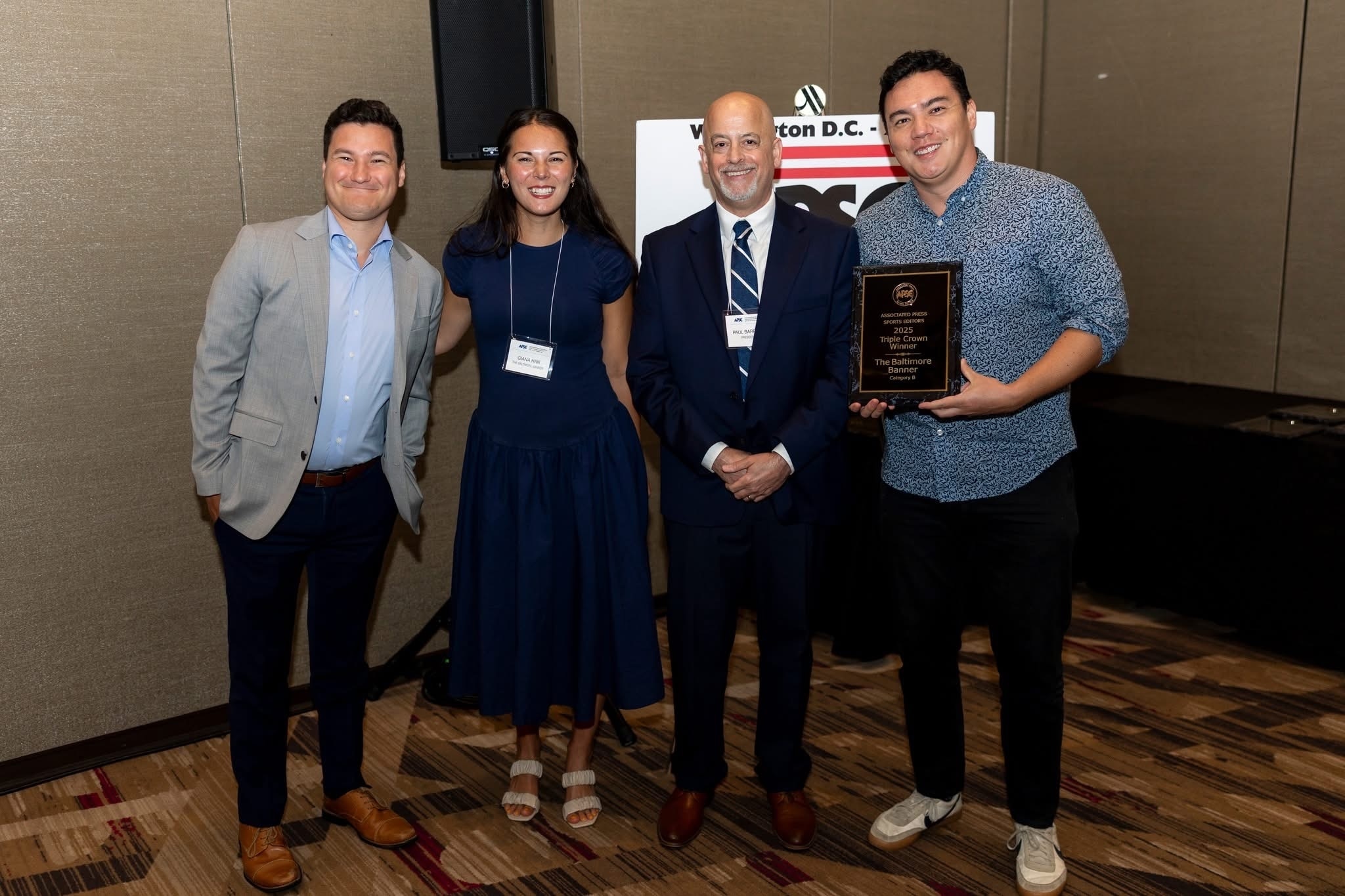 Banner sports staff members Paul Mancano, Giana Han and Kyle Goon receive a Triple Crown plaque from Associated Press Sports Editors President Paul Barrett. (Photo courtesy of APSE)