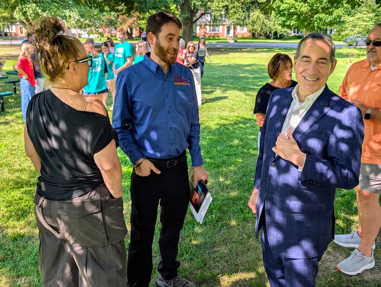 Dan Schwartz, the Democratic candidate for Congress in the 1st District, talks with U.S. Rep. Jamie Raskin and Cambridge United founder Michelle Fowle before a canvass of voters' homes in Easton on July 26, 2026.