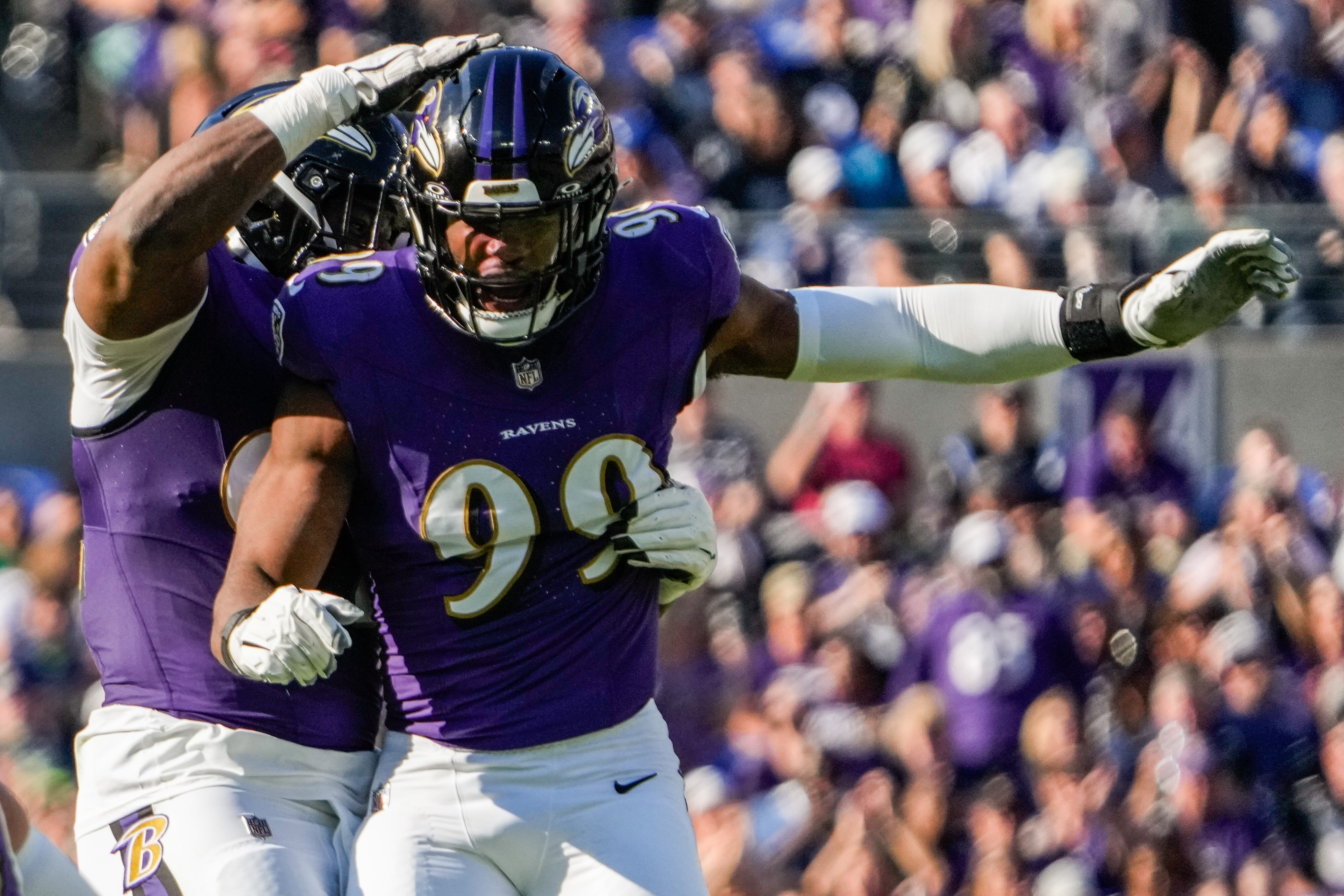 Baltimore Ravens linebacker Odafe Oweh (99) and defensive tackle Justin Madubuike (92) celebrate a sack during the second quarter against the Seattle Seahawks at M&T Bank Stadium on Sunday, Nov. 5, 2023.
