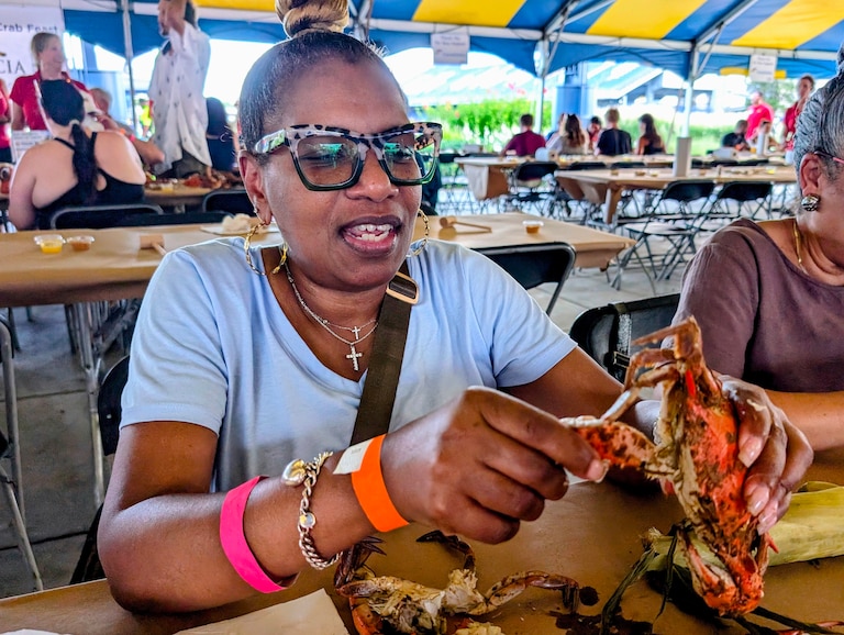 Dawn King of Randallstown shows how to open a Maryland steamed crab on Aug. 7, 2026 at the Annapolis Rotary Crab Festival.