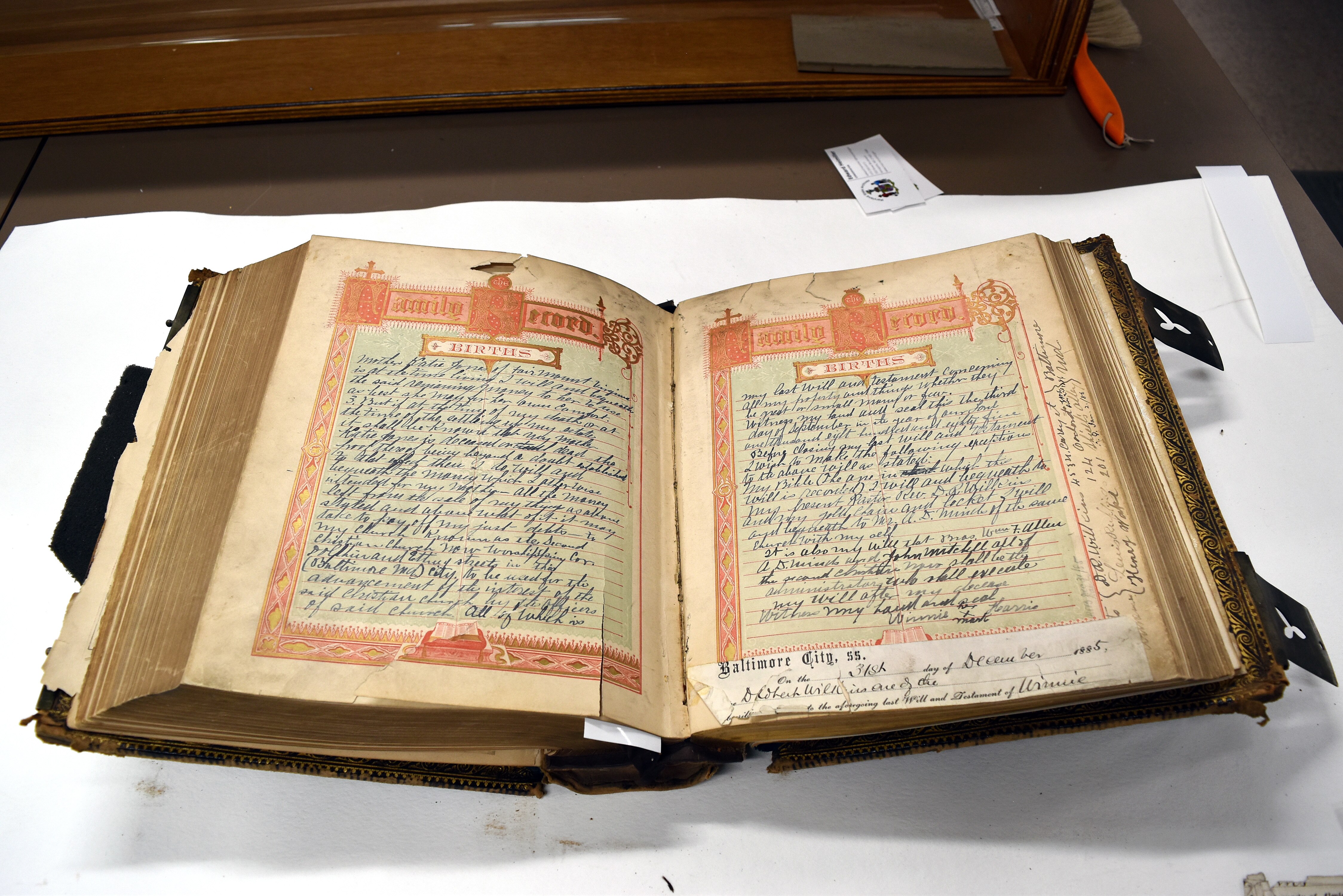 FEBRUARY 9, 2026 - Detail shots of the Harris family Bible show tin photos of a couple believed to be Harris and her husband, though the photos were not labeled. Her will is seen written in the family records section. The cover of the Bible features a leather veneer and gilded detail.