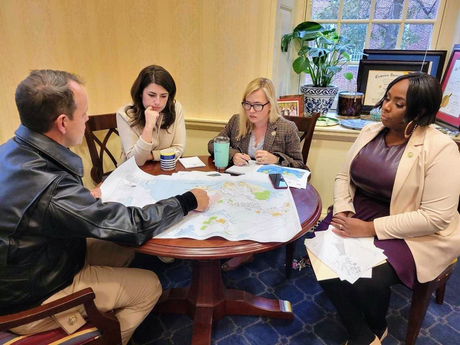 State Sen. Sarah Elfreth, second from left, works with Del. Dana Jones, center, and Del. Shaneka Henson. If Elfreth wins the 3rd District seat in Congress, both Jones and Henson have said they plan to seek an appointment to her position.