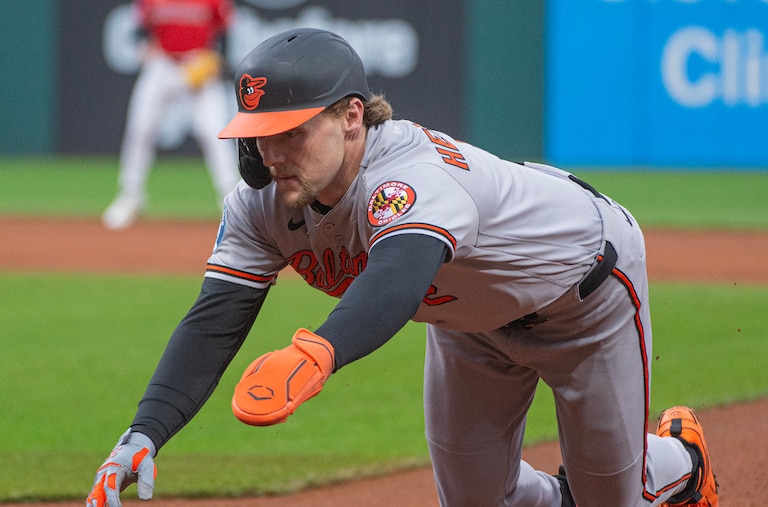 Gunnar Henderson dives back to first base during the first inning of a game against the Cleveland Guardians on April 18.