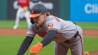 Gunnar Henderson dives back to first base during the first inning of a game against the Cleveland Guardians on April 18.