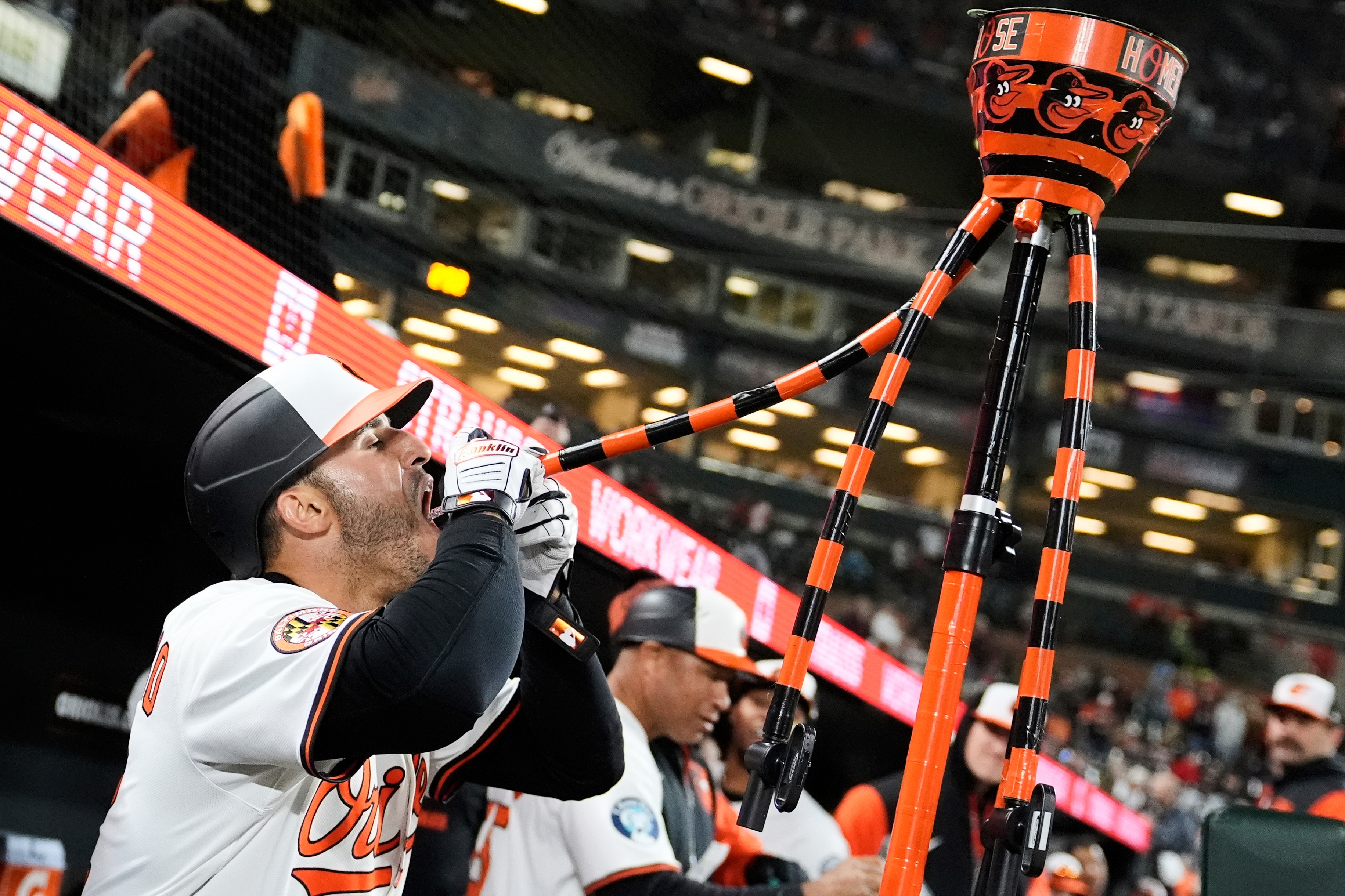 Baltimore Orioles' Ramon Laureano celebrates his home run by drinking water from the team's "Homer Hydration Station" during the seventh inning of a baseball game against the Cleveland Guardians, Wednesday, April 16, 2025, in Baltimore.