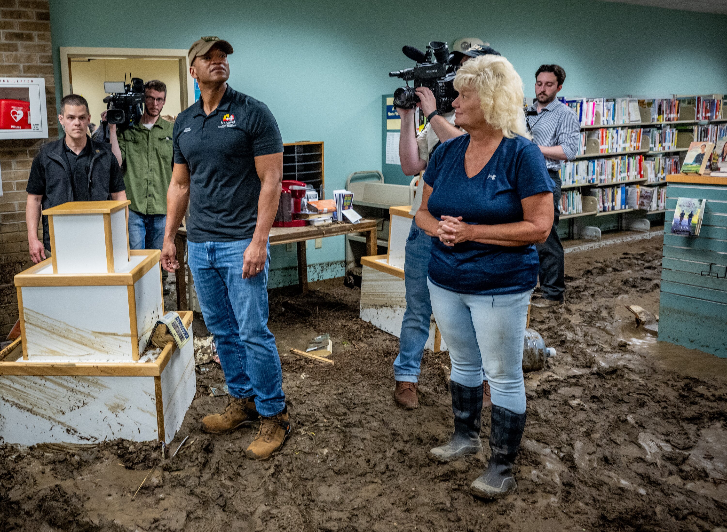 Gov. Wes Moore surveys the damage to the Westernport Library on May 15, two days after a storm caused catastrophic flooding in the area.