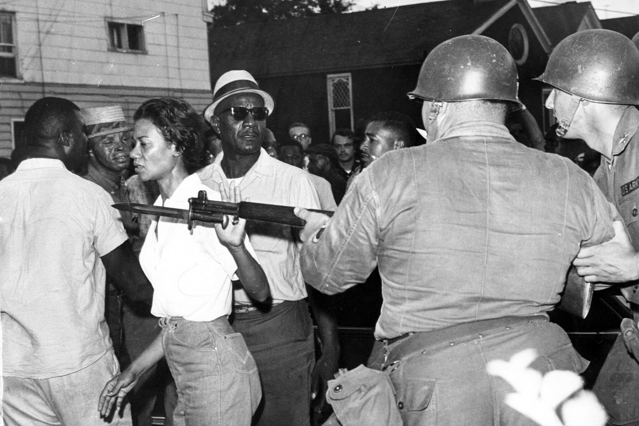 FILE - Gloria Richardson, head of the Cambridge Nonviolent Action Committee, pushes a National Guardsman's bayonet aside as she moves among a crowd of African Americans to convince them to disperse in Cambridge, Md., on July 21, 1963. Richardson, an influential yet largely unsung civil rights pioneer whose determination not to back down while protesting racial inequality was captured in a photograph as she pushed away the bayonet of a National Guardsman, died July 15, 2021, in New York.
