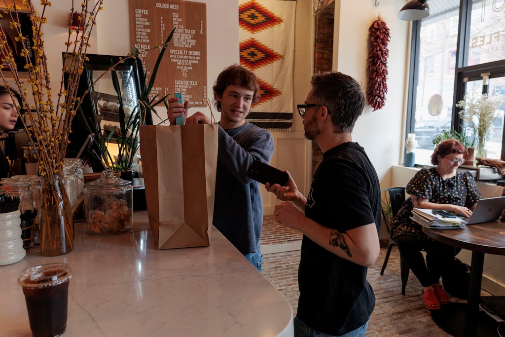 Elliot Schaffer, an employee at Golden West Cafe in Hampden, packs a takeout order.